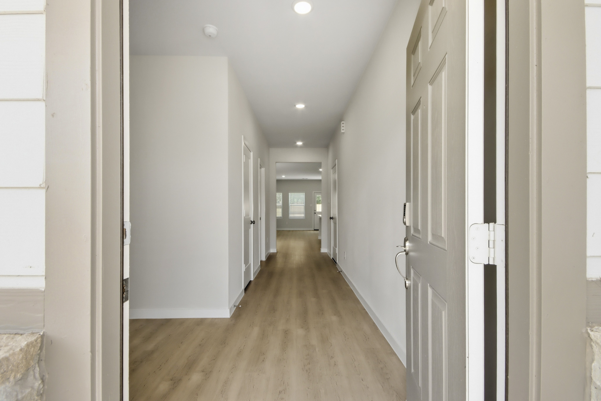 A hallway with white doors.