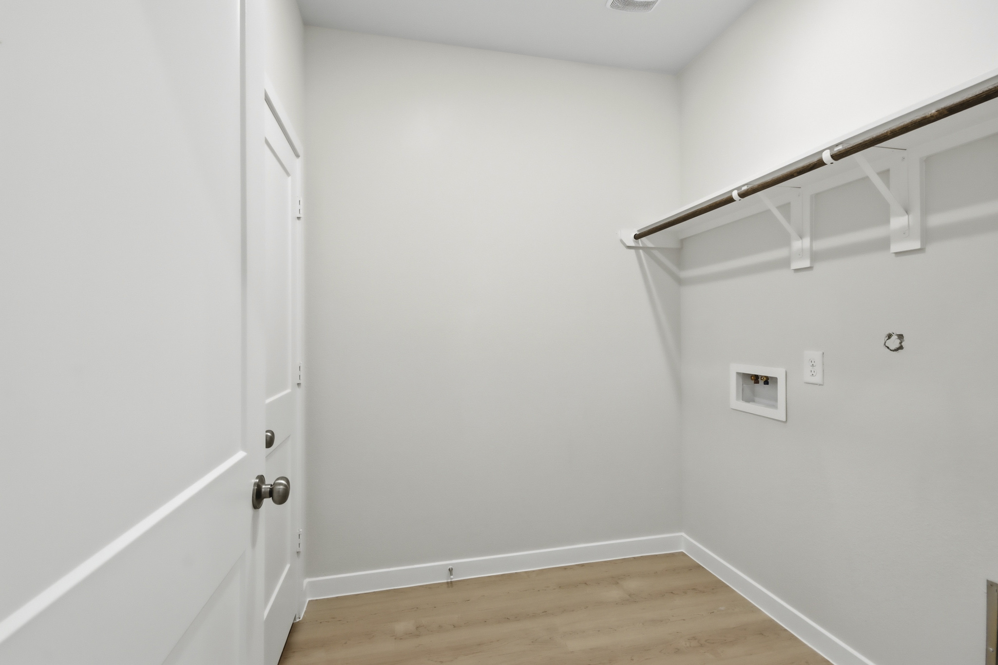 A room with white walls and a wood floor.