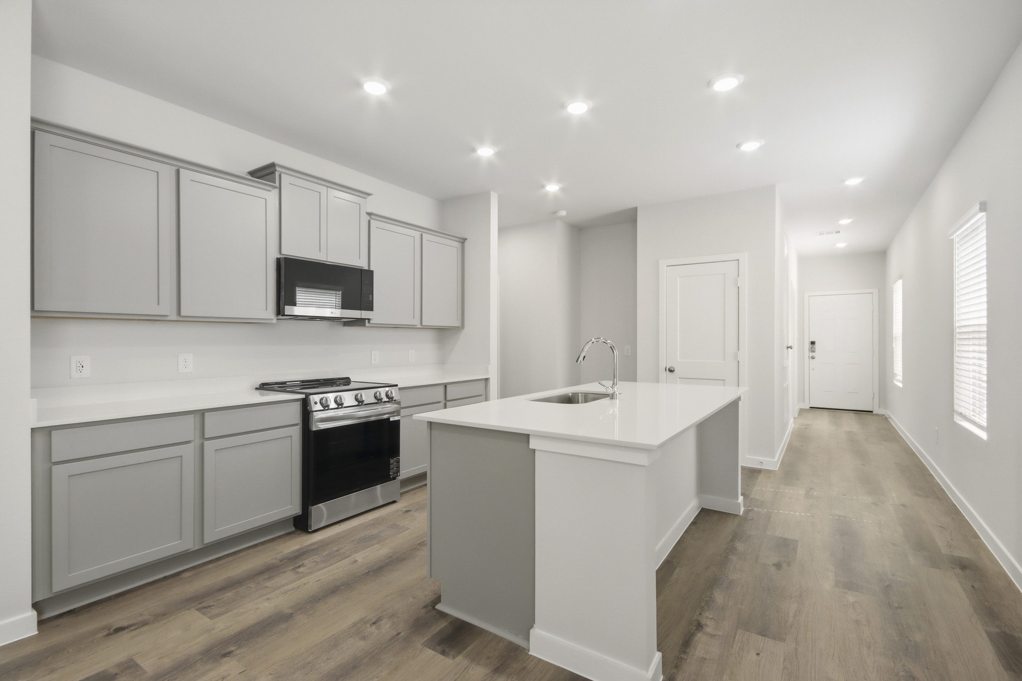 A kitchen with white cabinets.