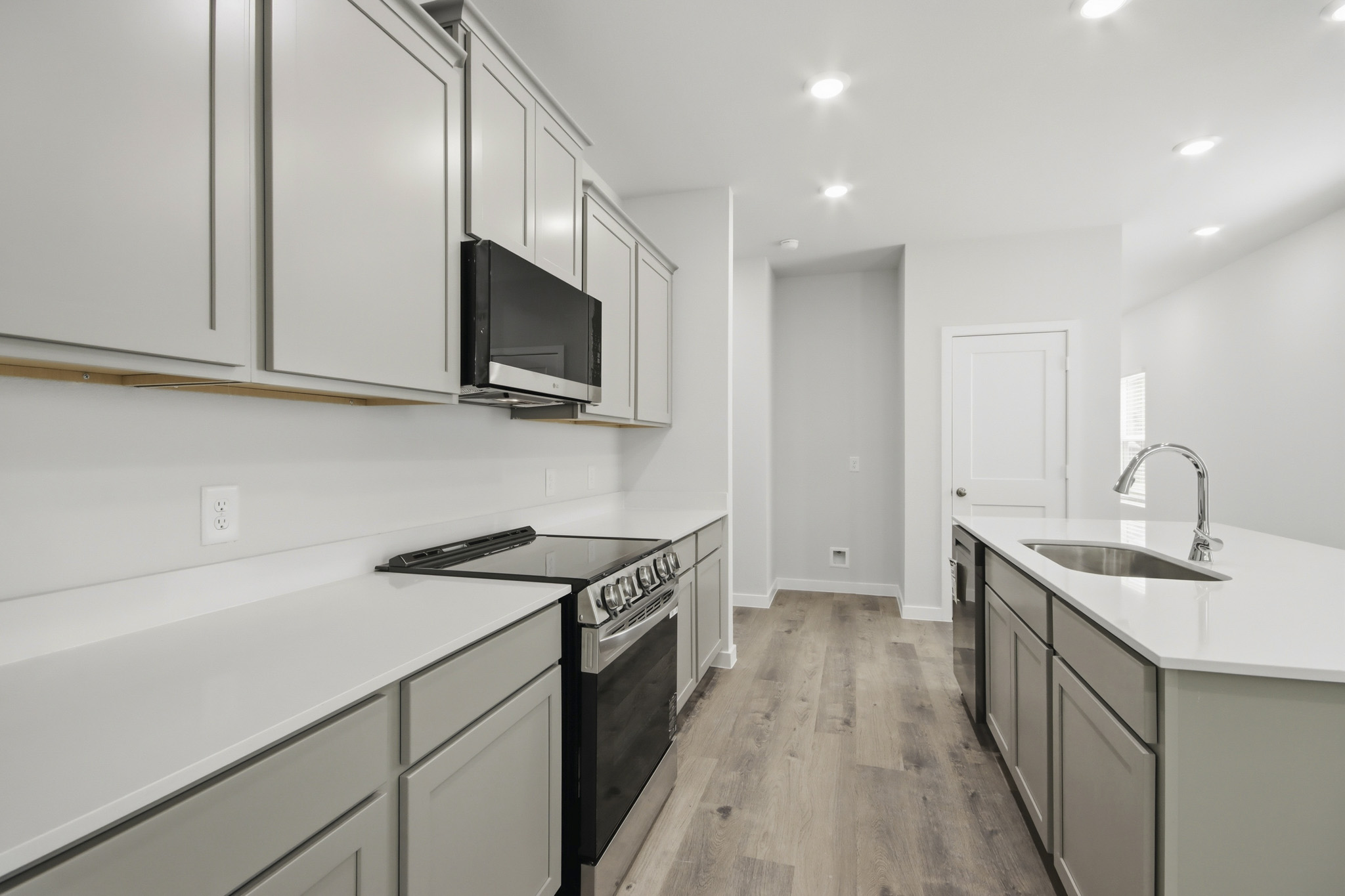 A kitchen with white cabinets.