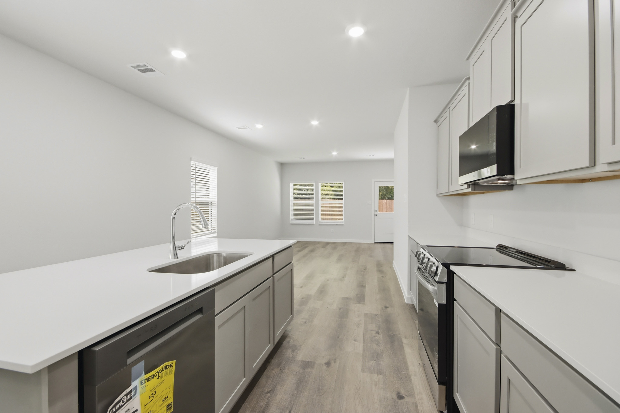A kitchen with white cabinets.