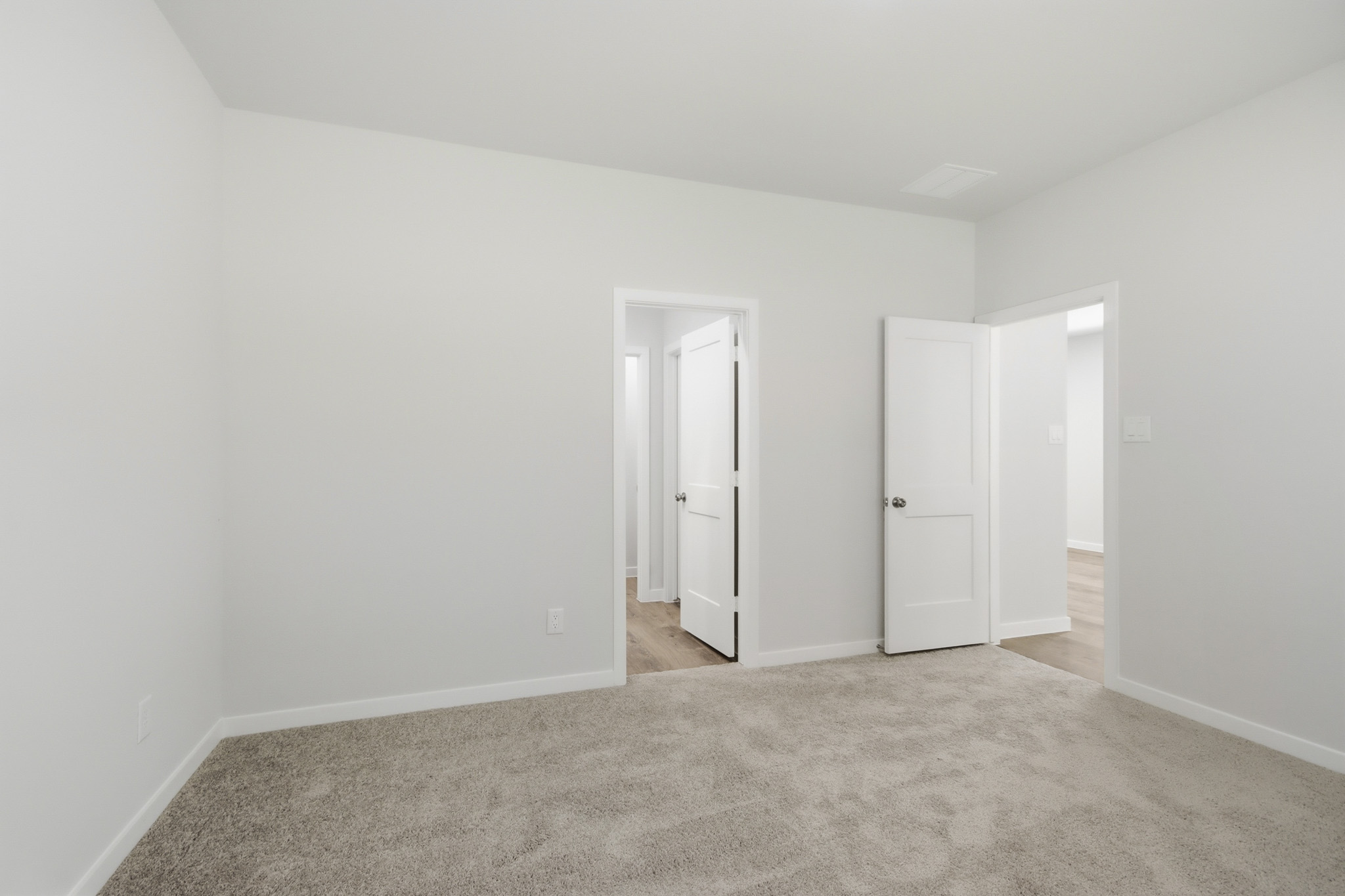 A hallway with white doors.