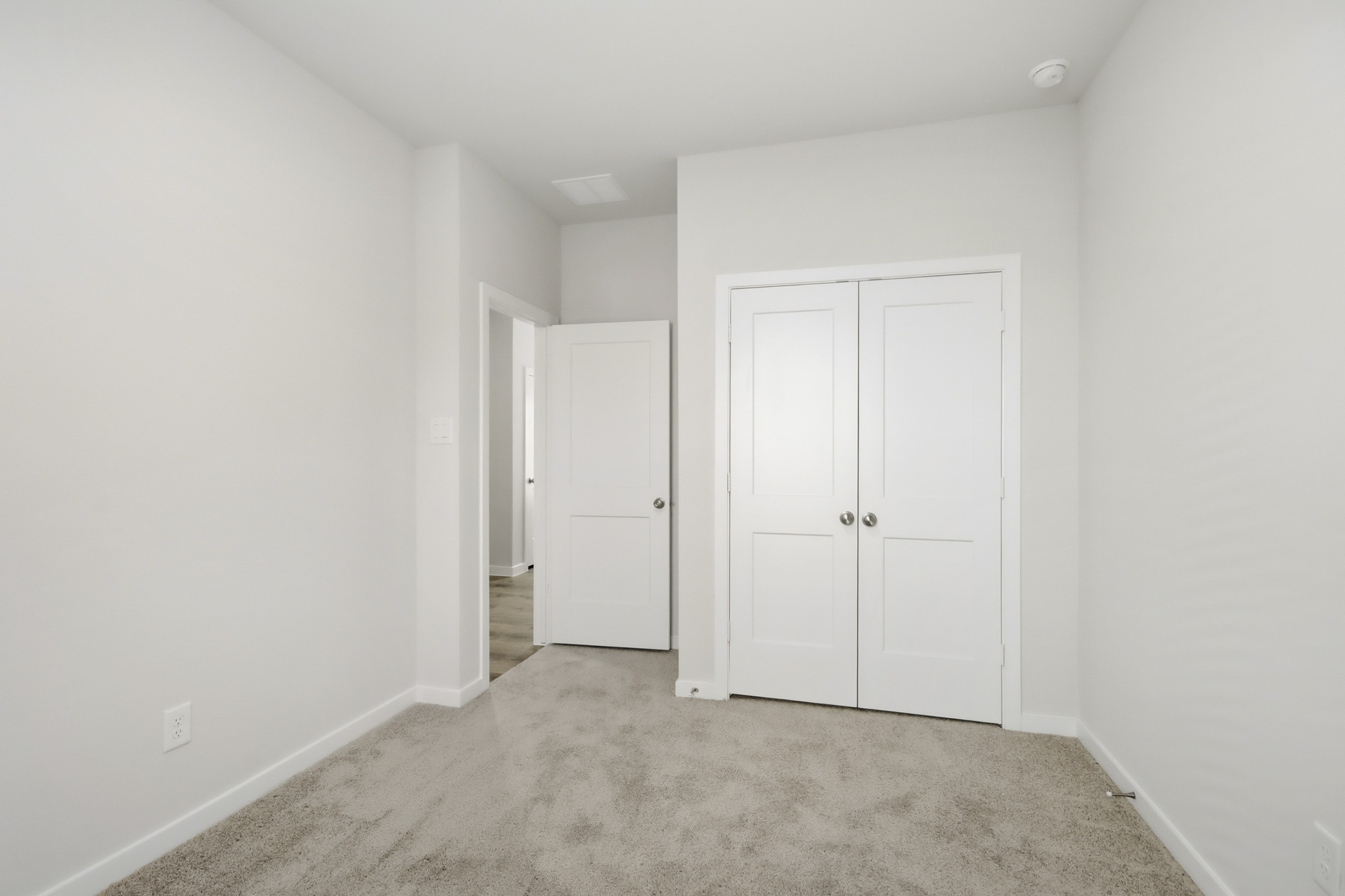 A hallway with white doors.