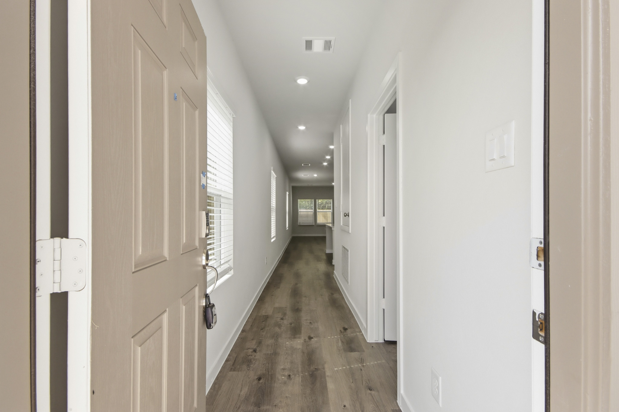 A hallway with white doors.