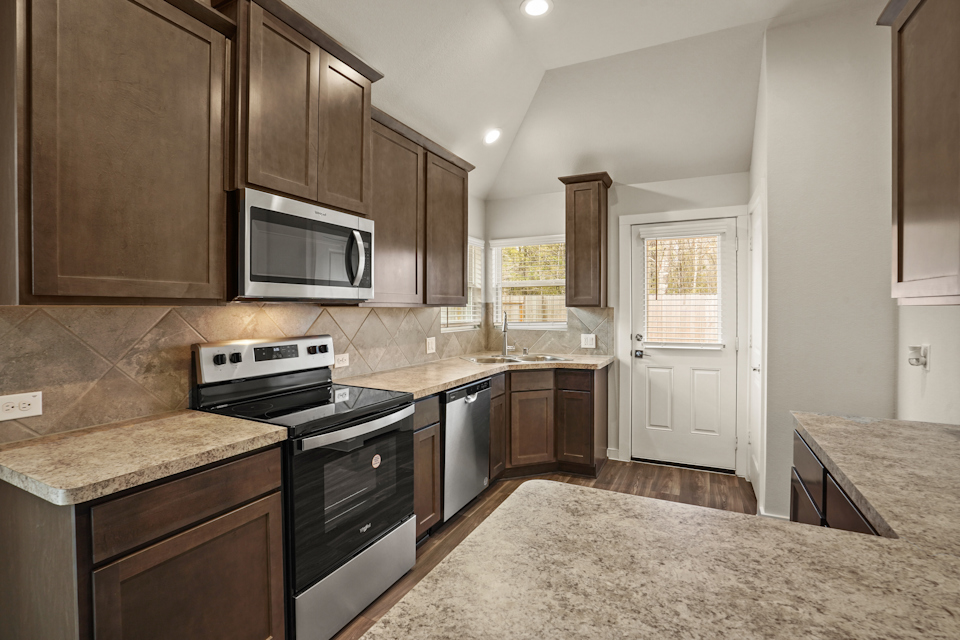 A kitchen with wooden cabinets.