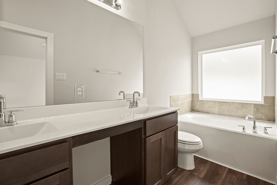 A bathroom with a tub sink and toilet.