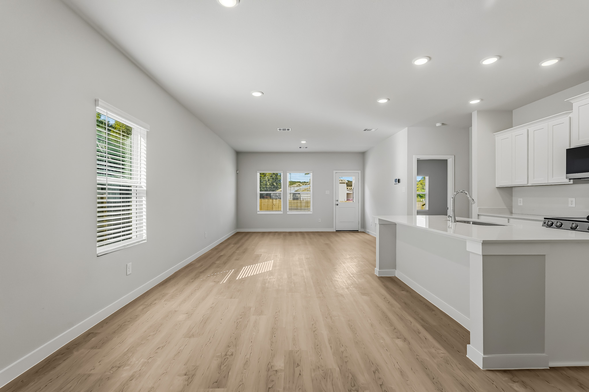 A kitchen with white cabinets.