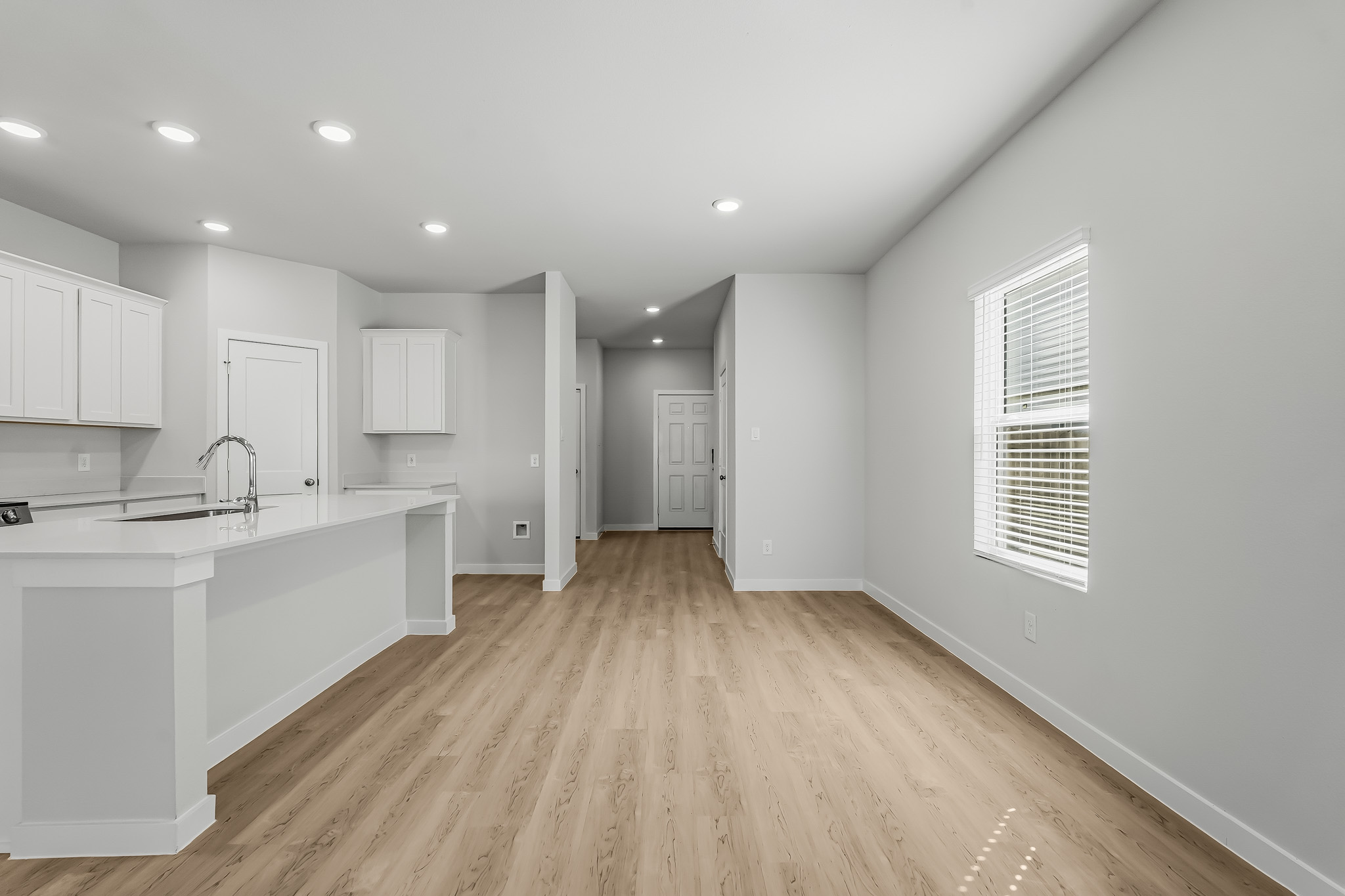A kitchen with white cabinets.