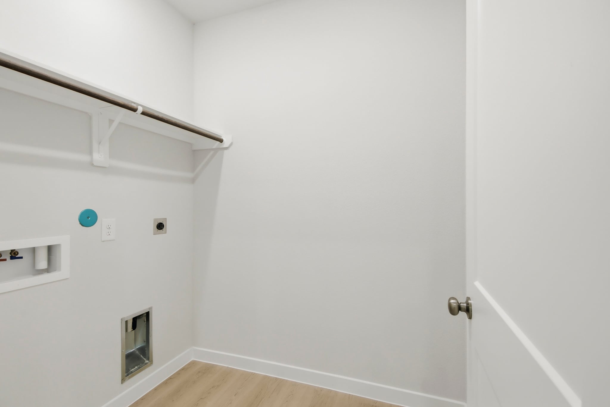 A white room with a white door.