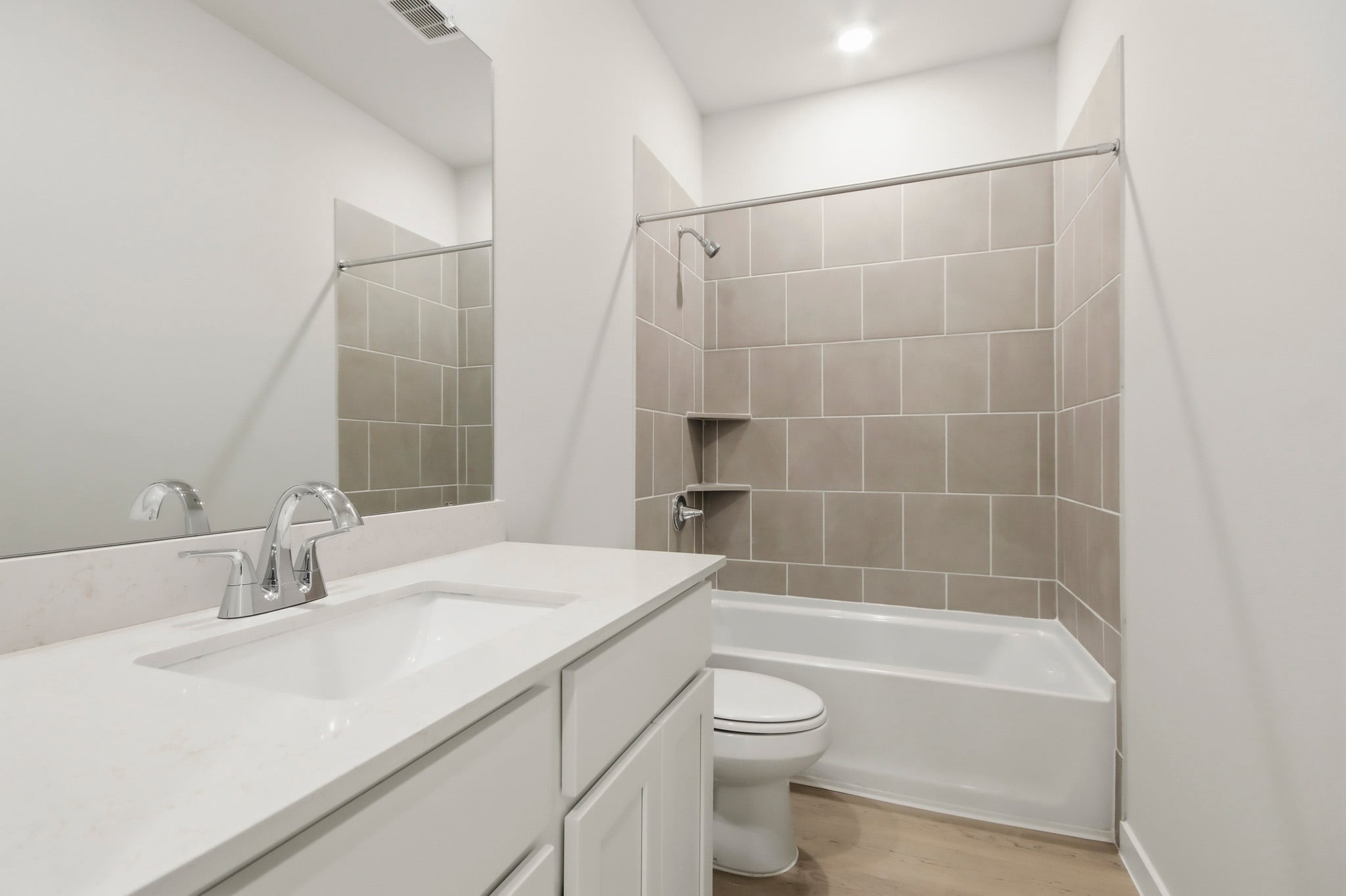 A bathroom with a tub sink and toilet.