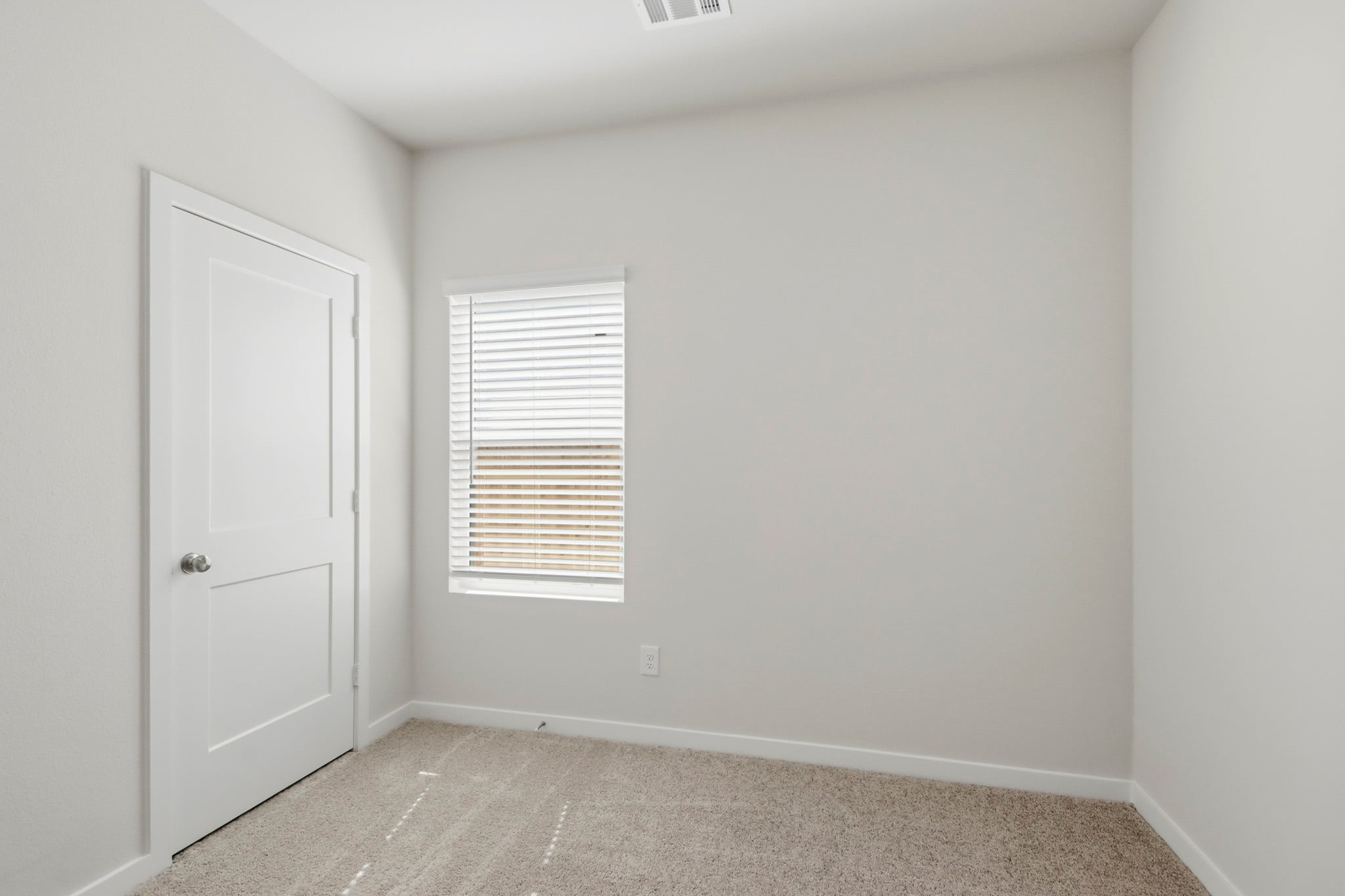 A room with a door and a window.