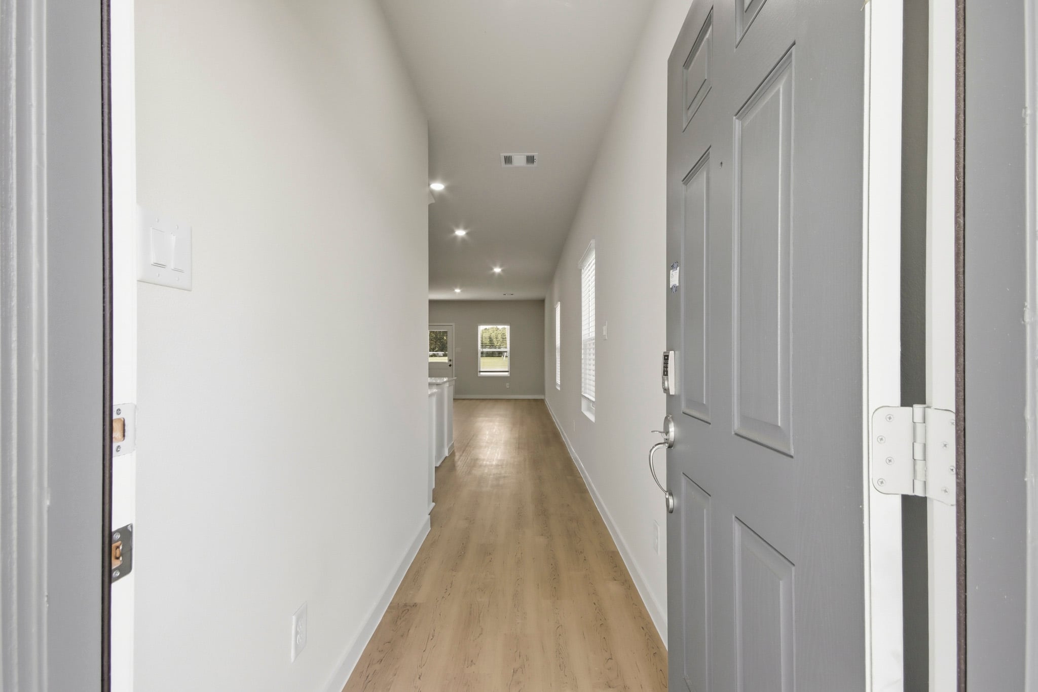 A hallway with white doors.
