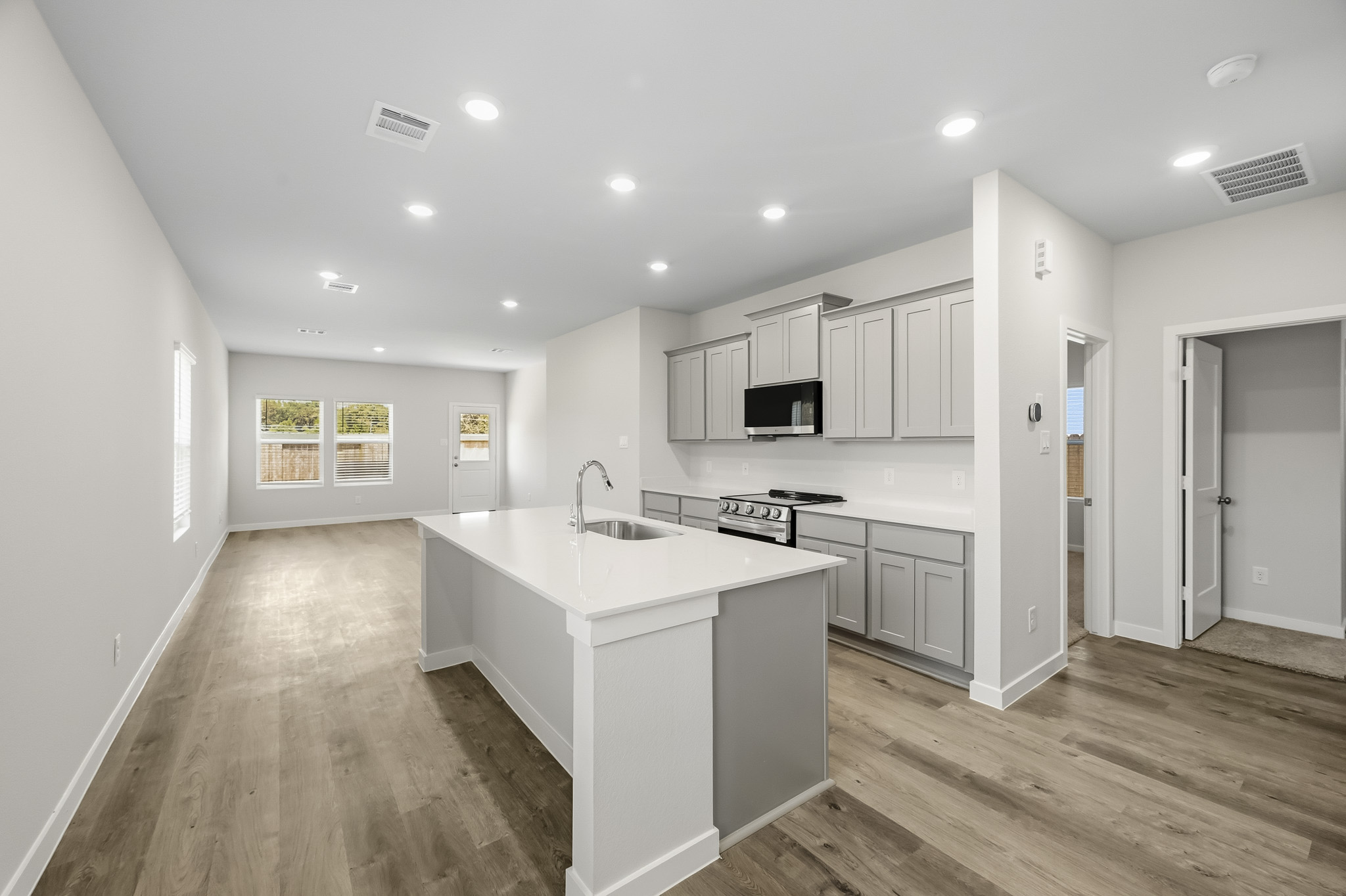 A kitchen with white cabinets.