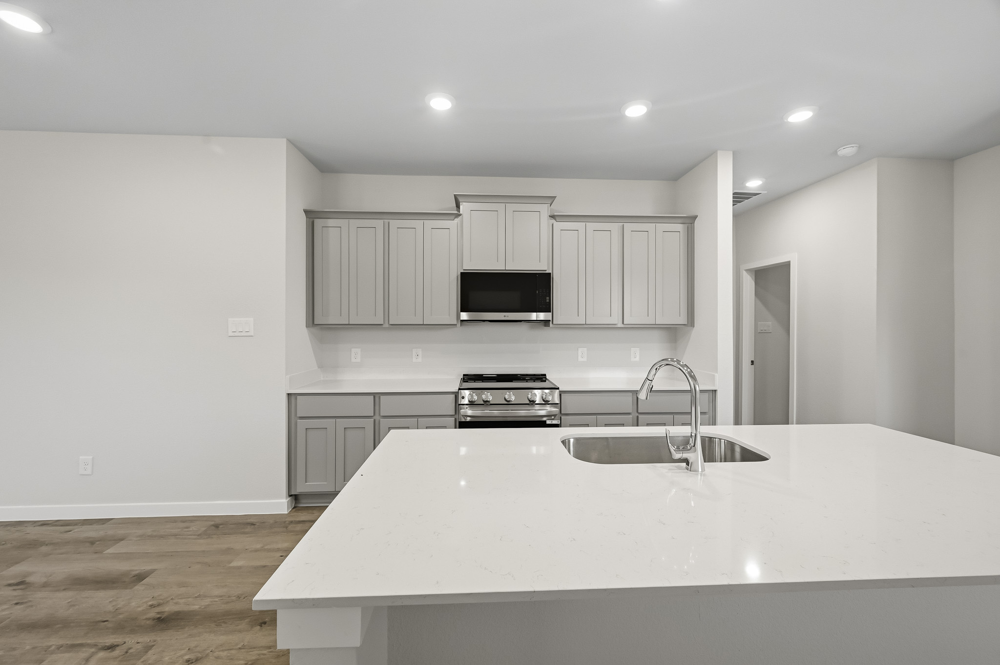A kitchen with white cabinets.