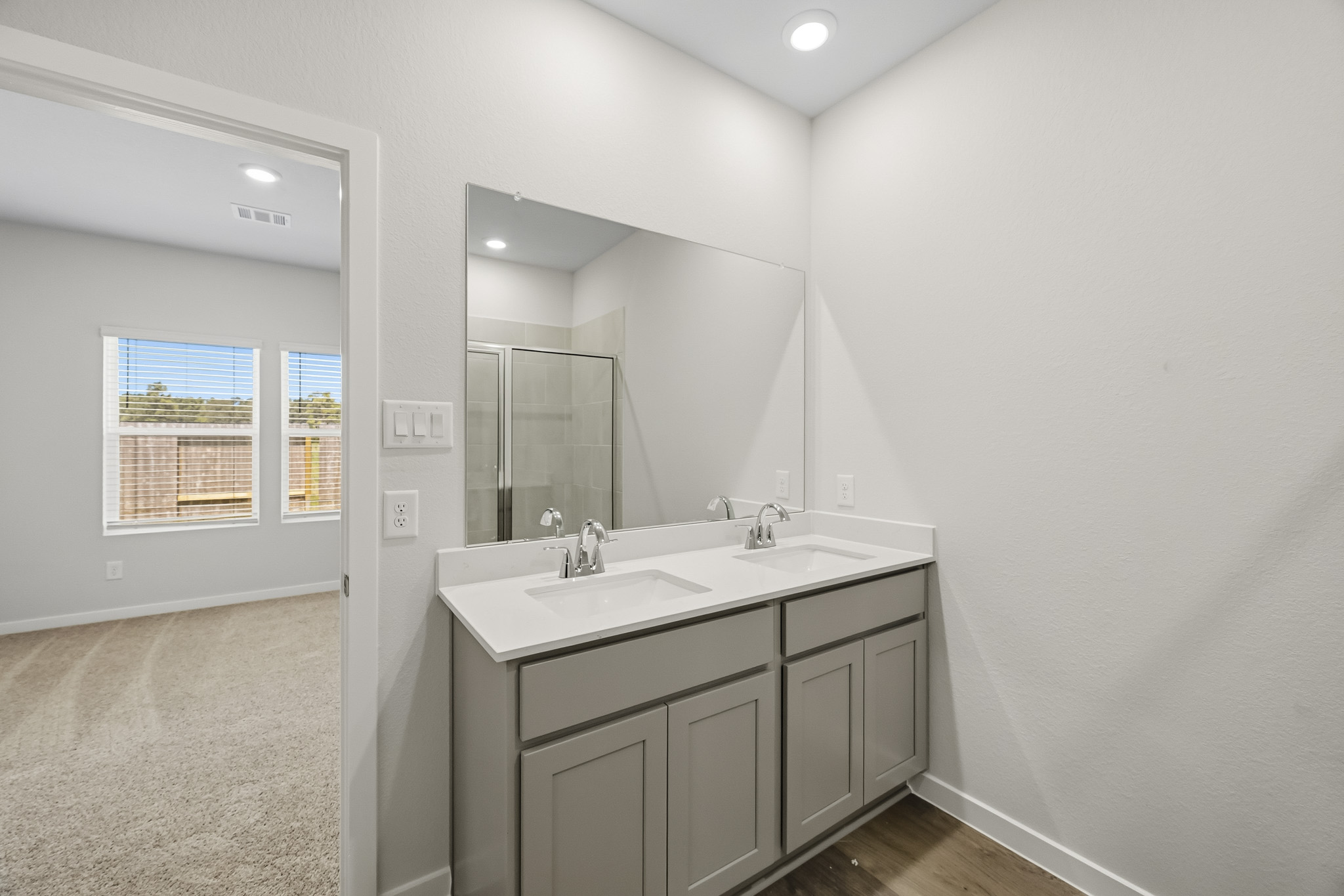 A bathroom with a large mirror.