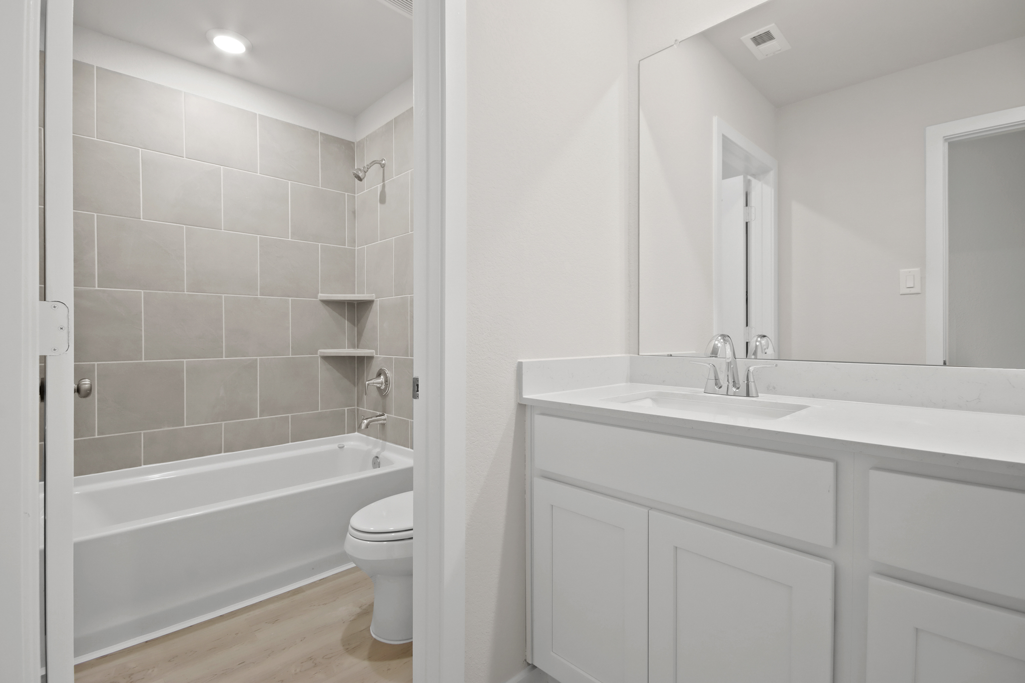 A bathroom with a tub sink and toilet.