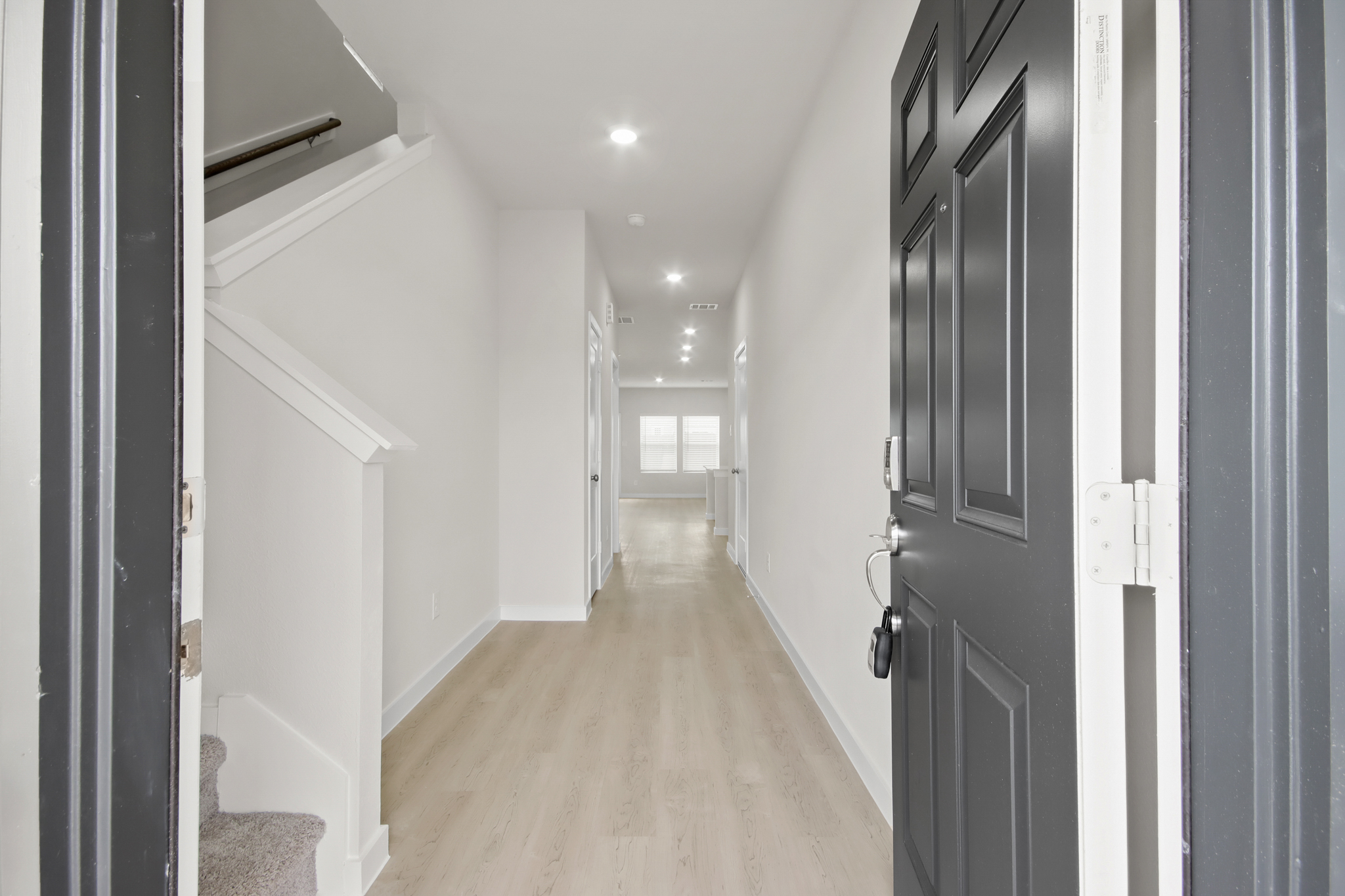 A hallway with black doors.