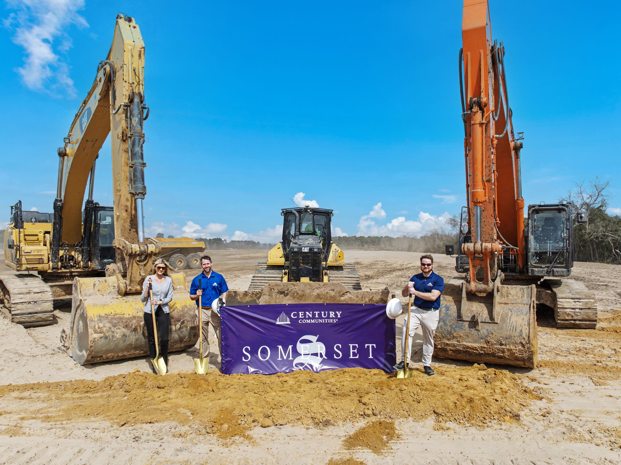 A few men standing next to a sign.