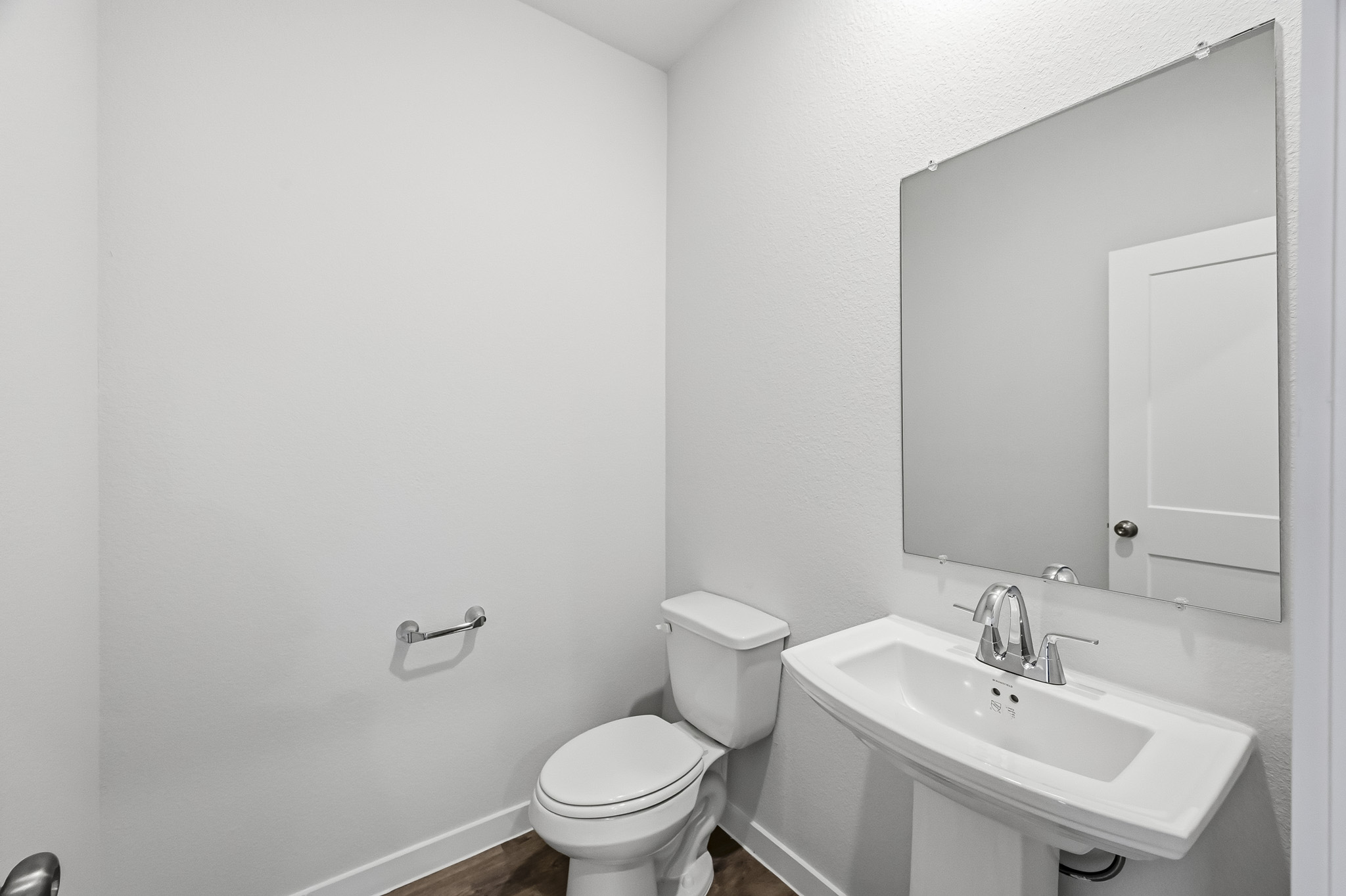 A bathroom with a toilet and sink.