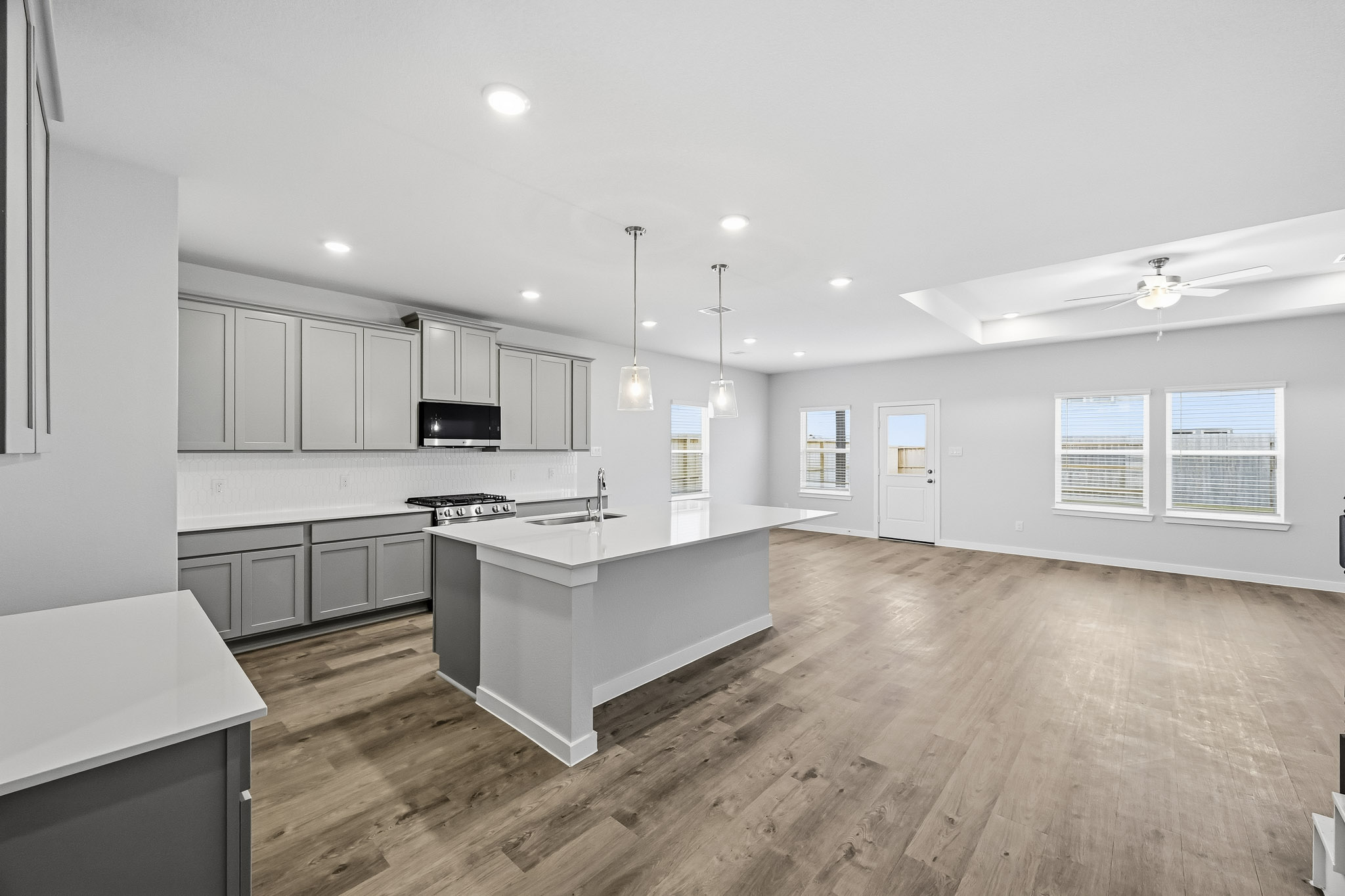 A kitchen with white cabinets.