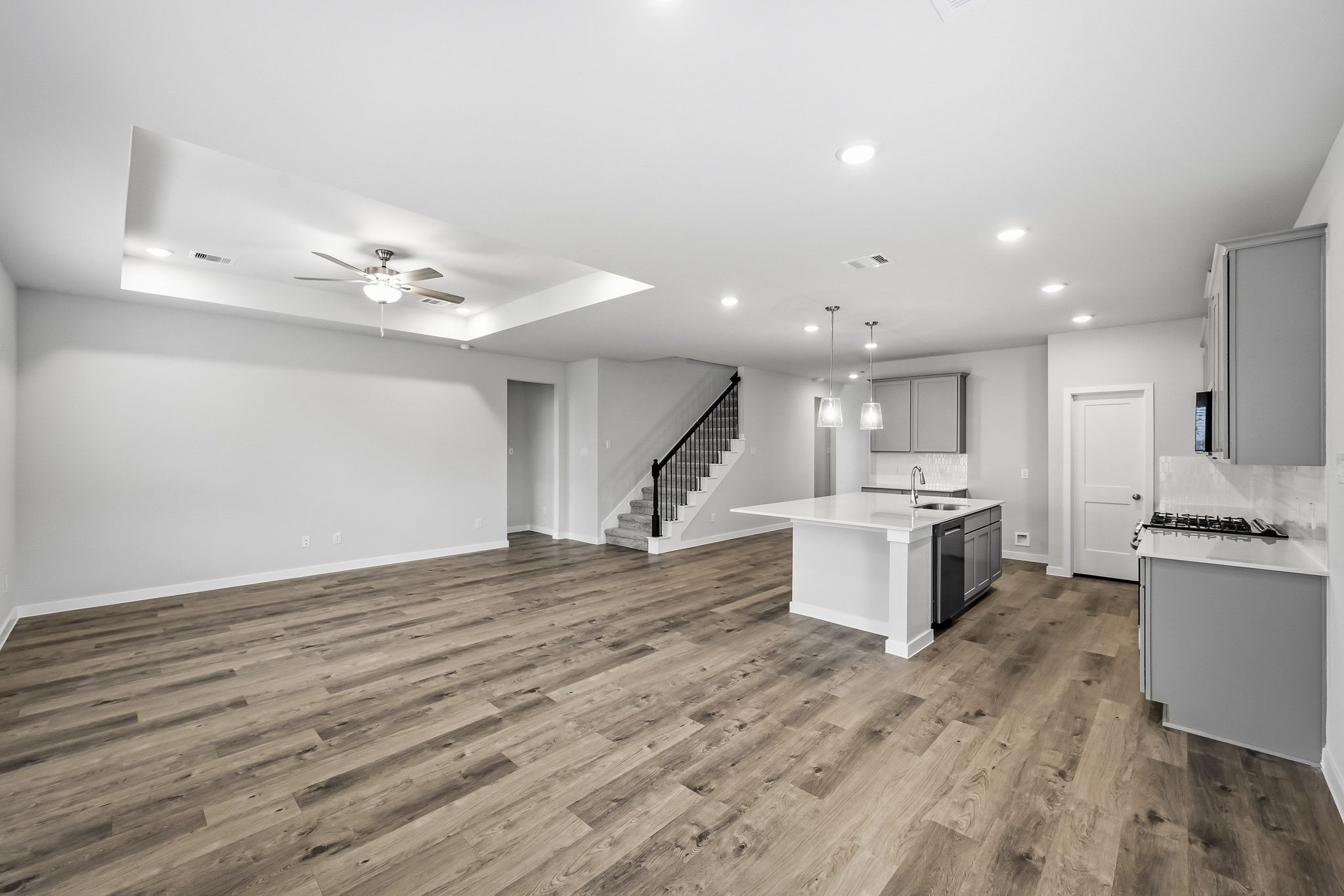 A large kitchen with wood floors.