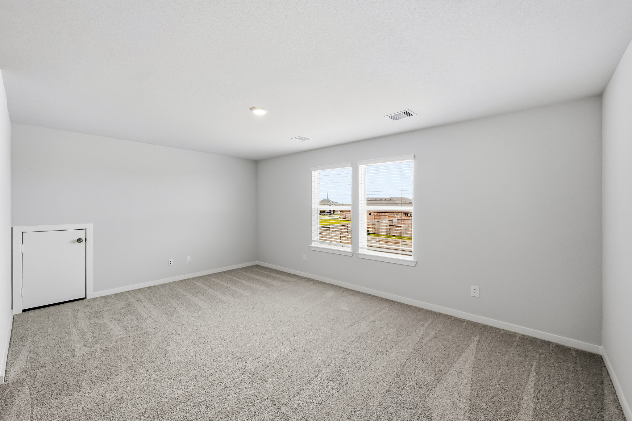 A room with a window and a door.
