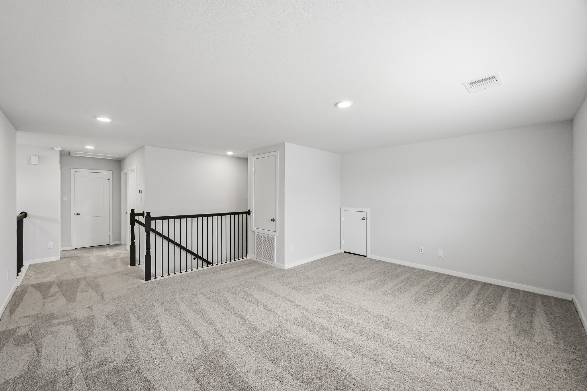 A room with a staircase and a railing.