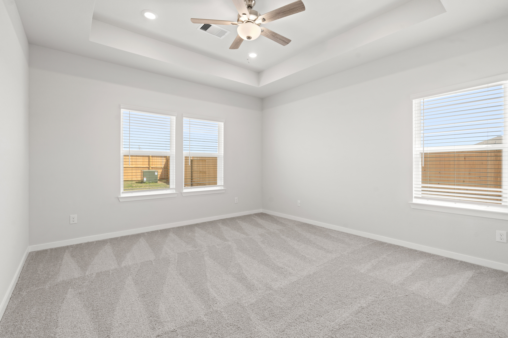 A room with a ceiling fan and a window.