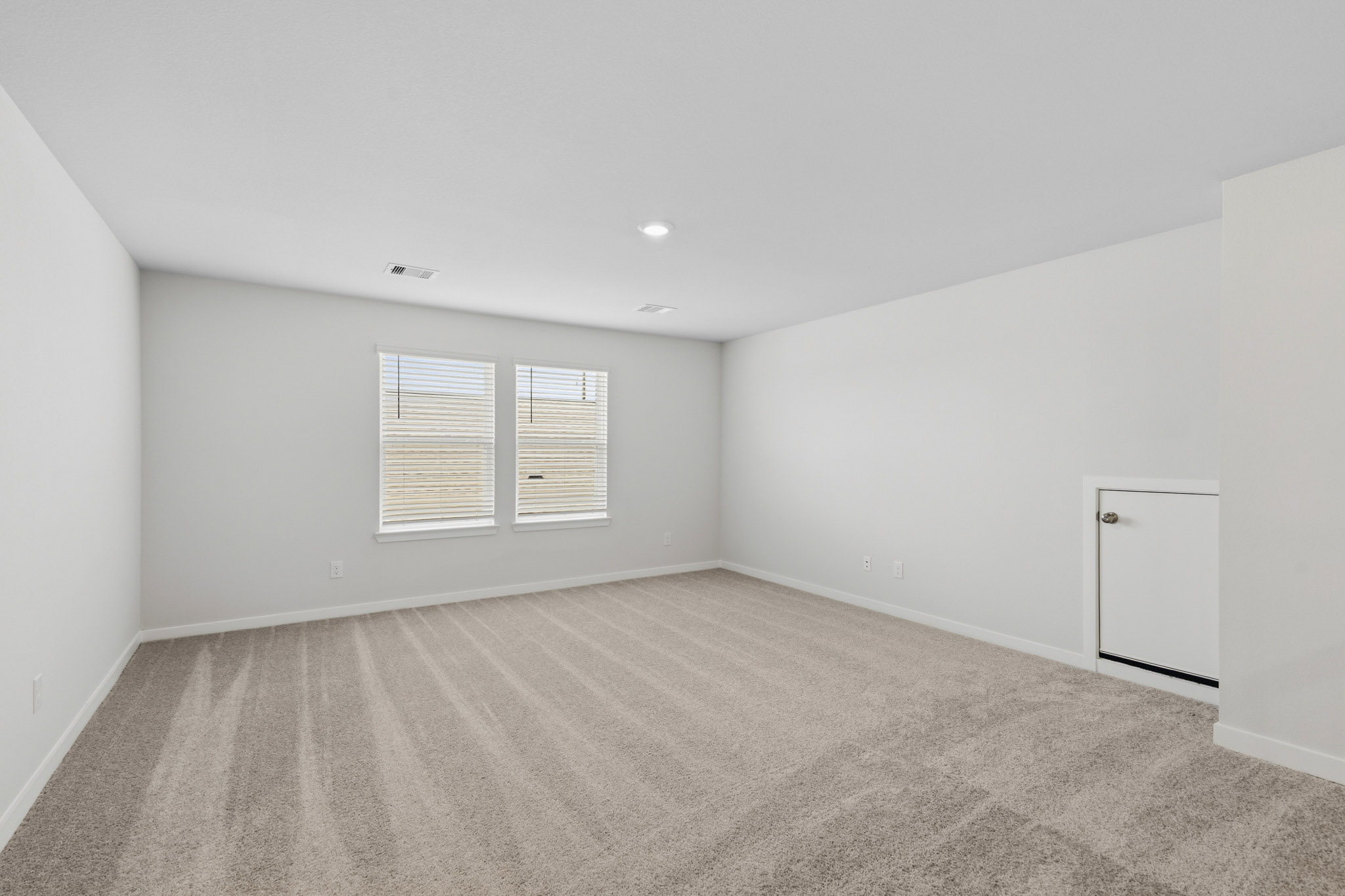 A room with a white wall and a white cabinet.