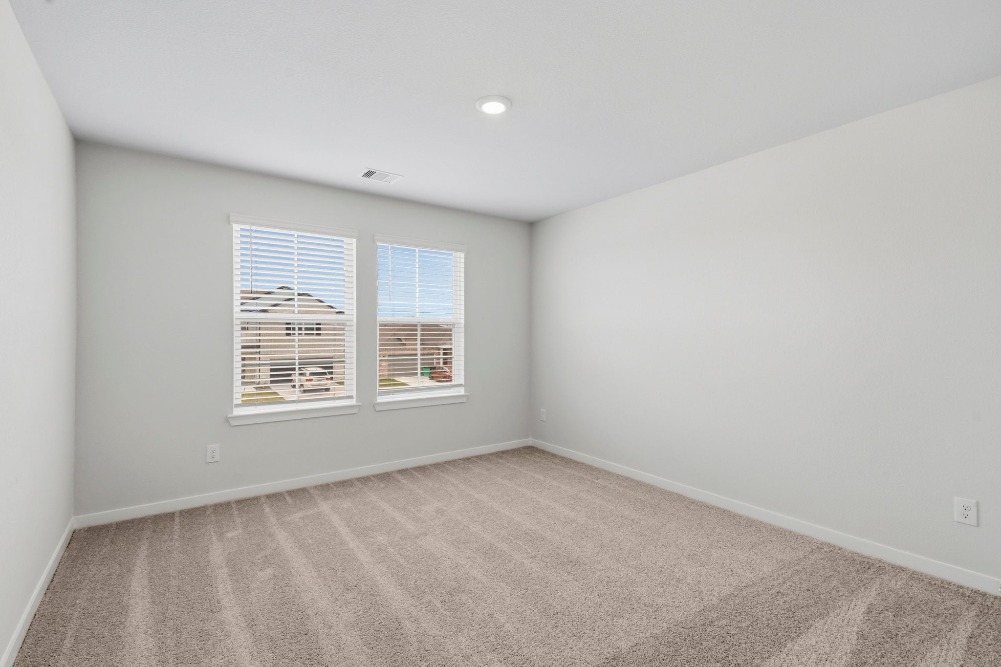 A room with a window and a carpet.