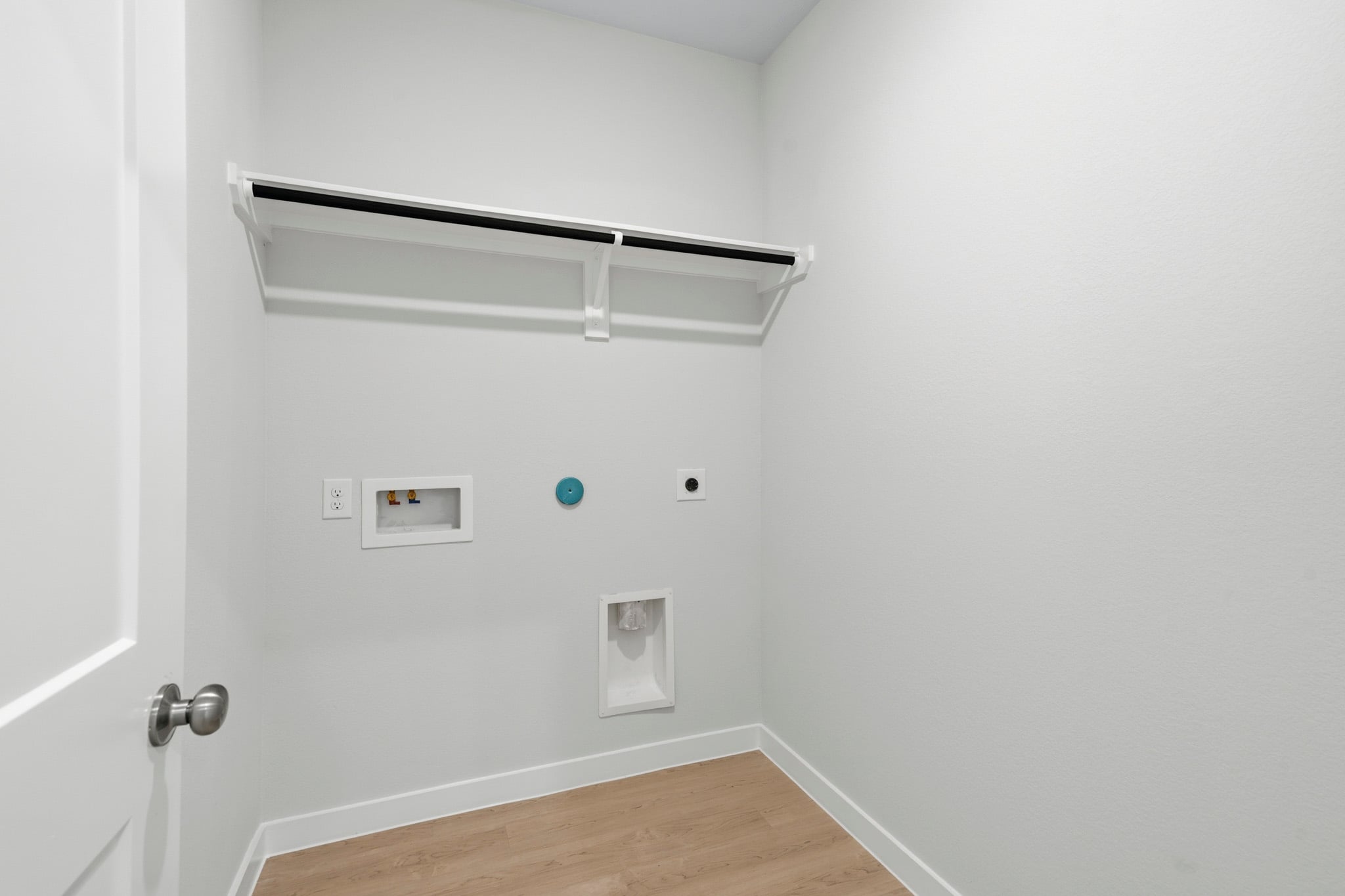 A white wall with a light fixture.