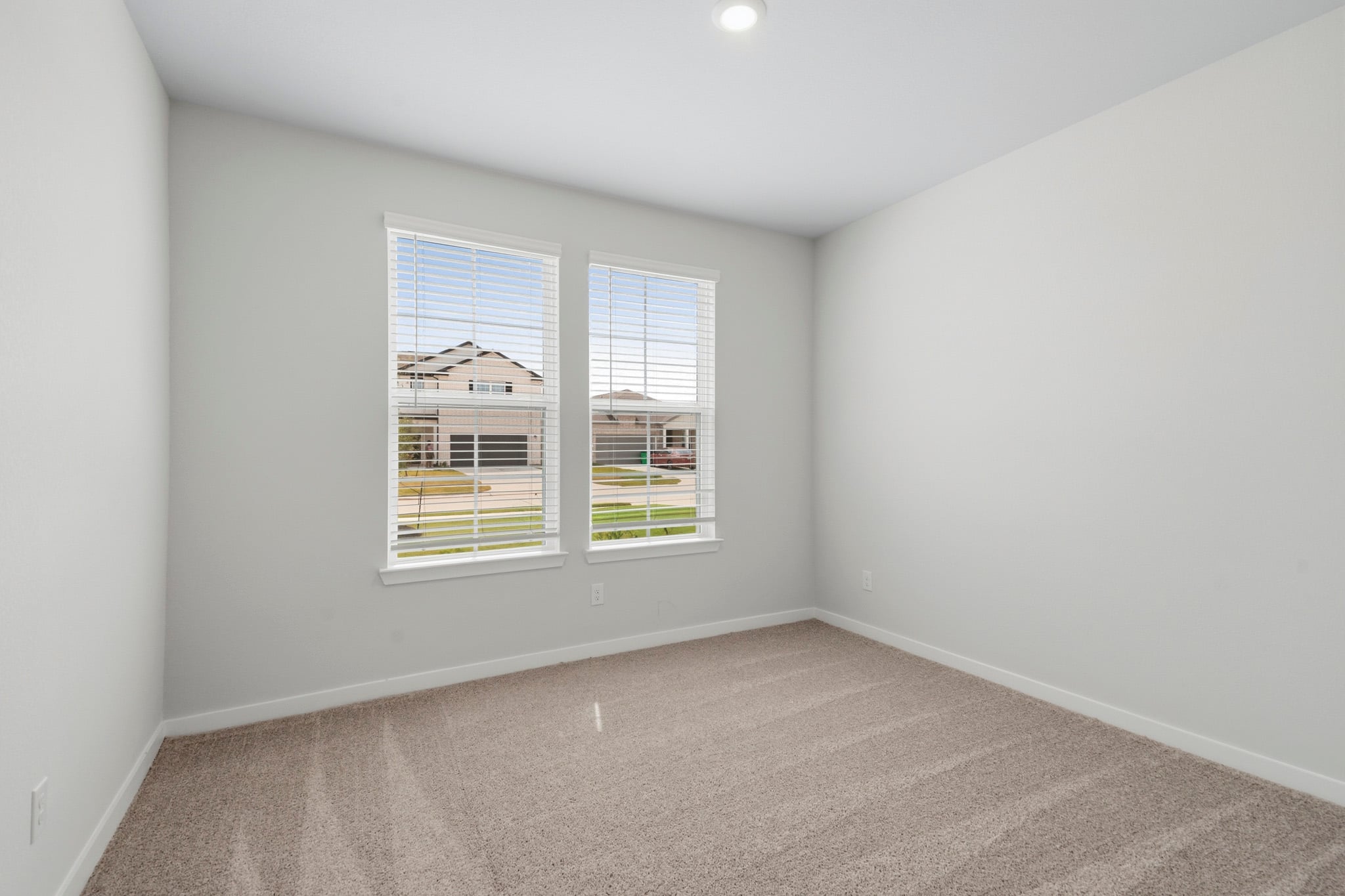 A room with a window and a carpet.
