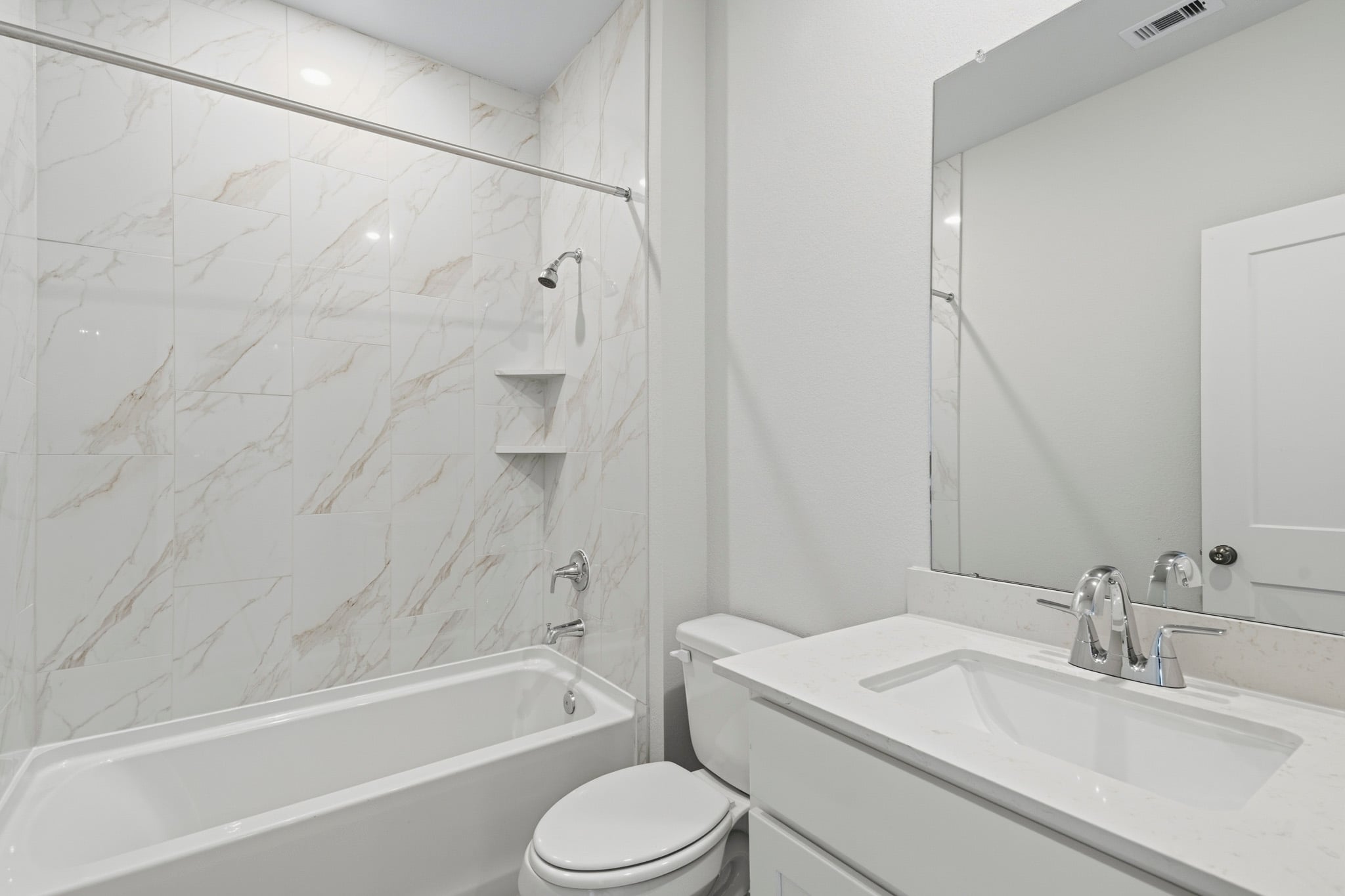 A bathroom with a sink toilet and bathtub.