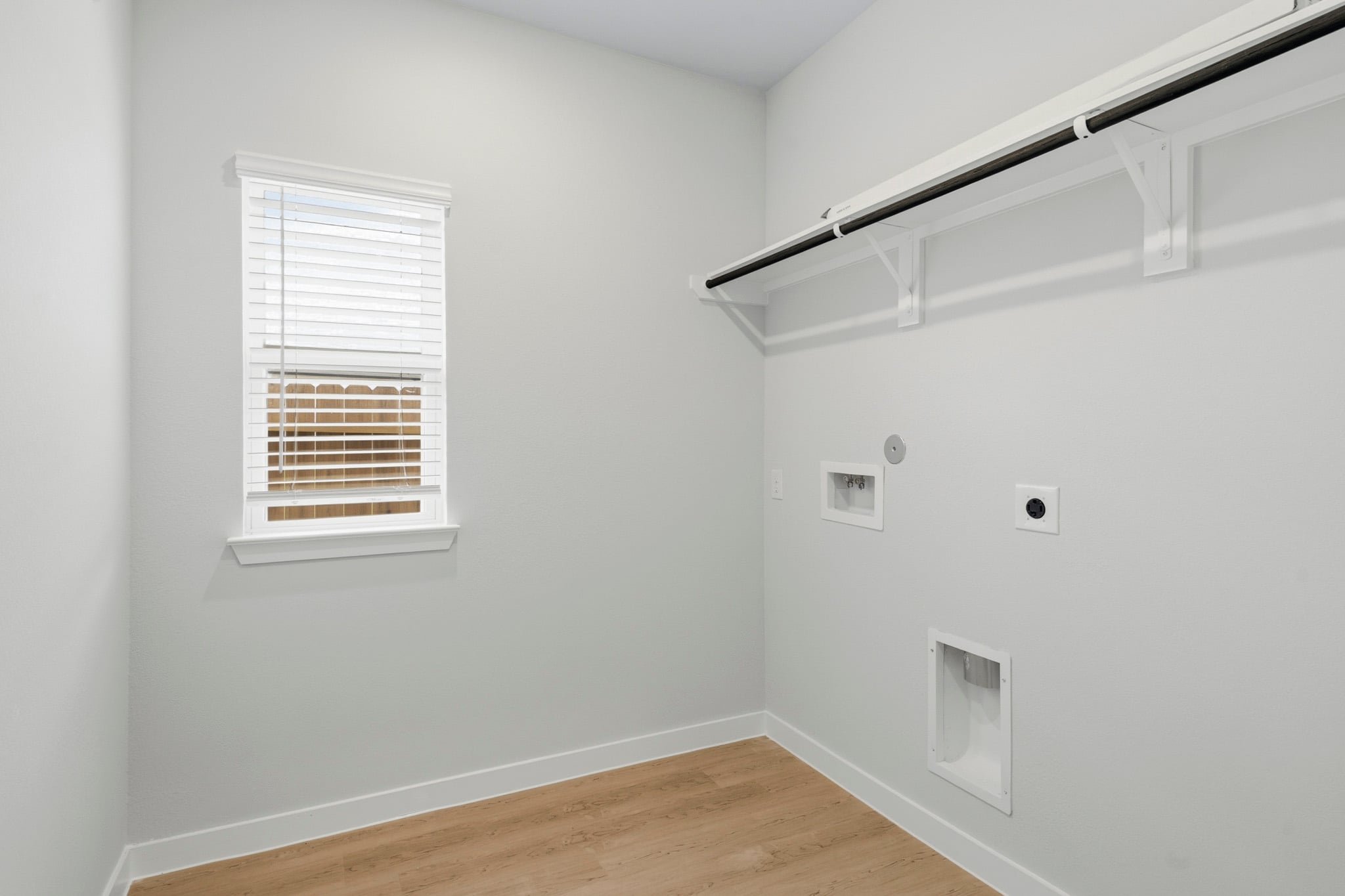 A room with a wood floor and white walls.
