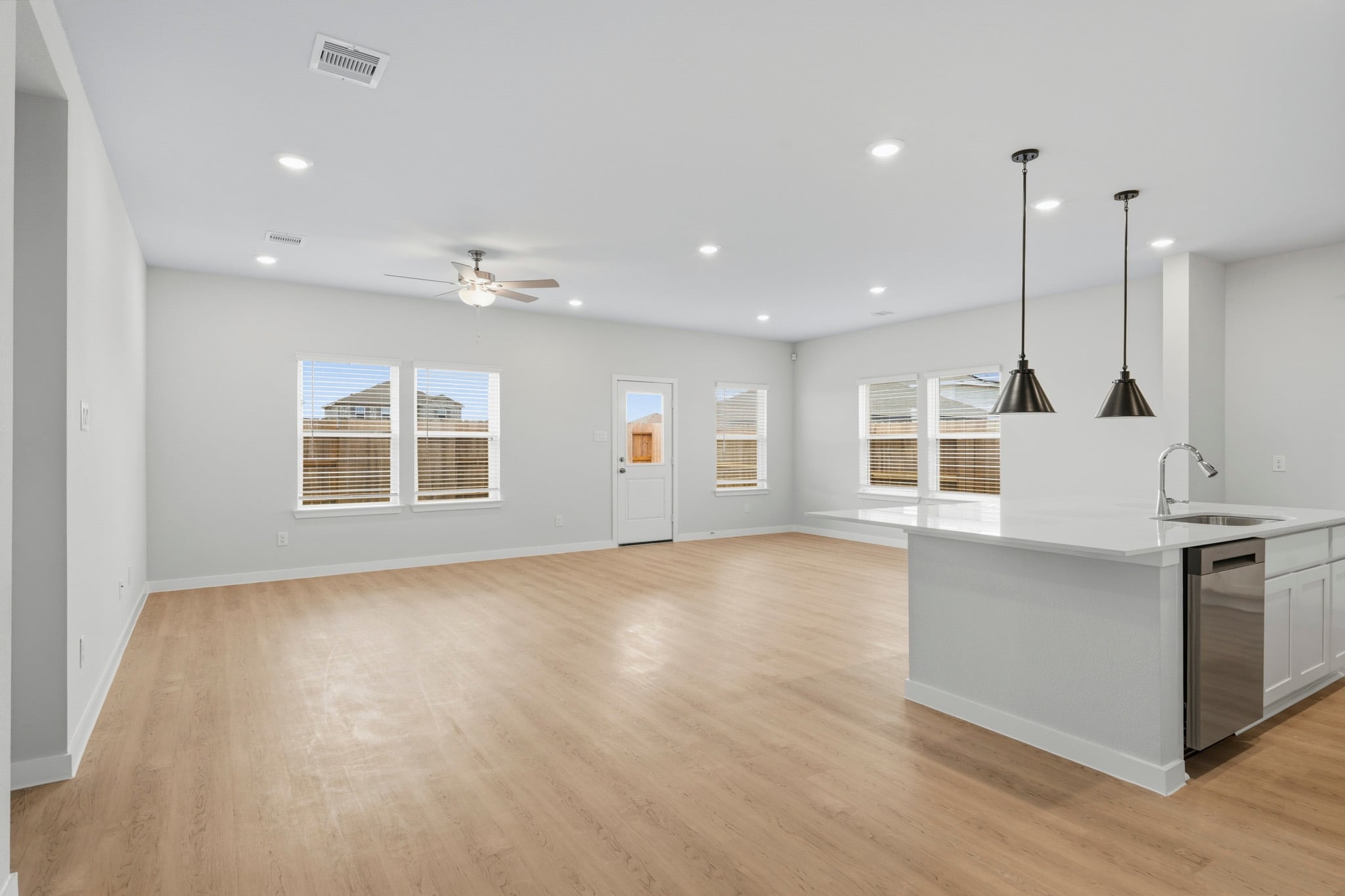A kitchen with white cabinets.