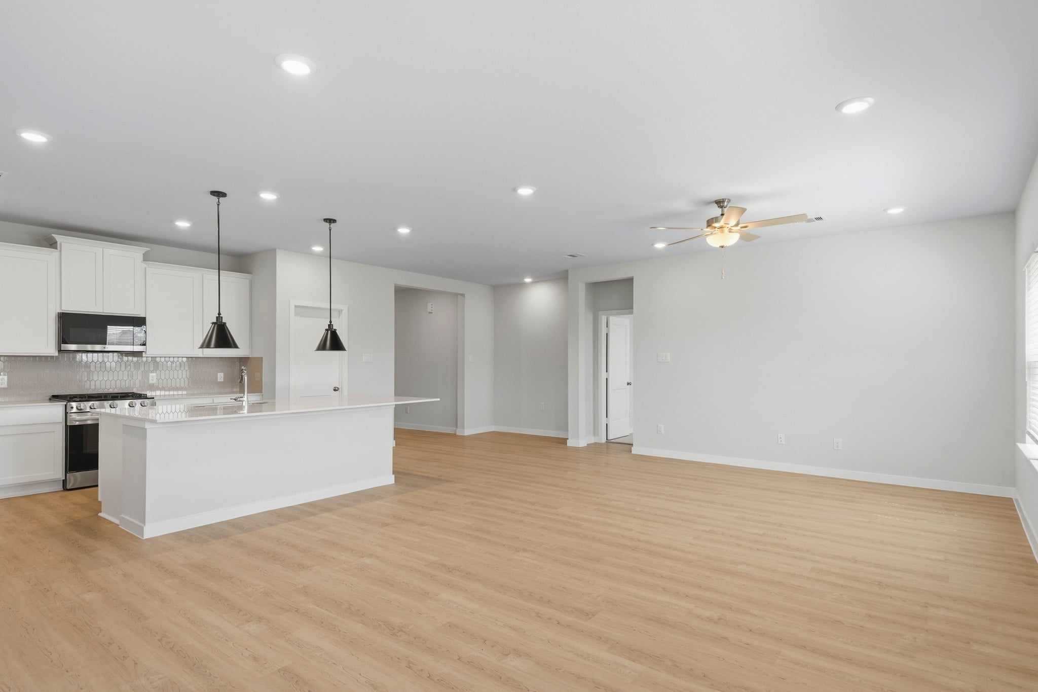 A kitchen with white cabinets.