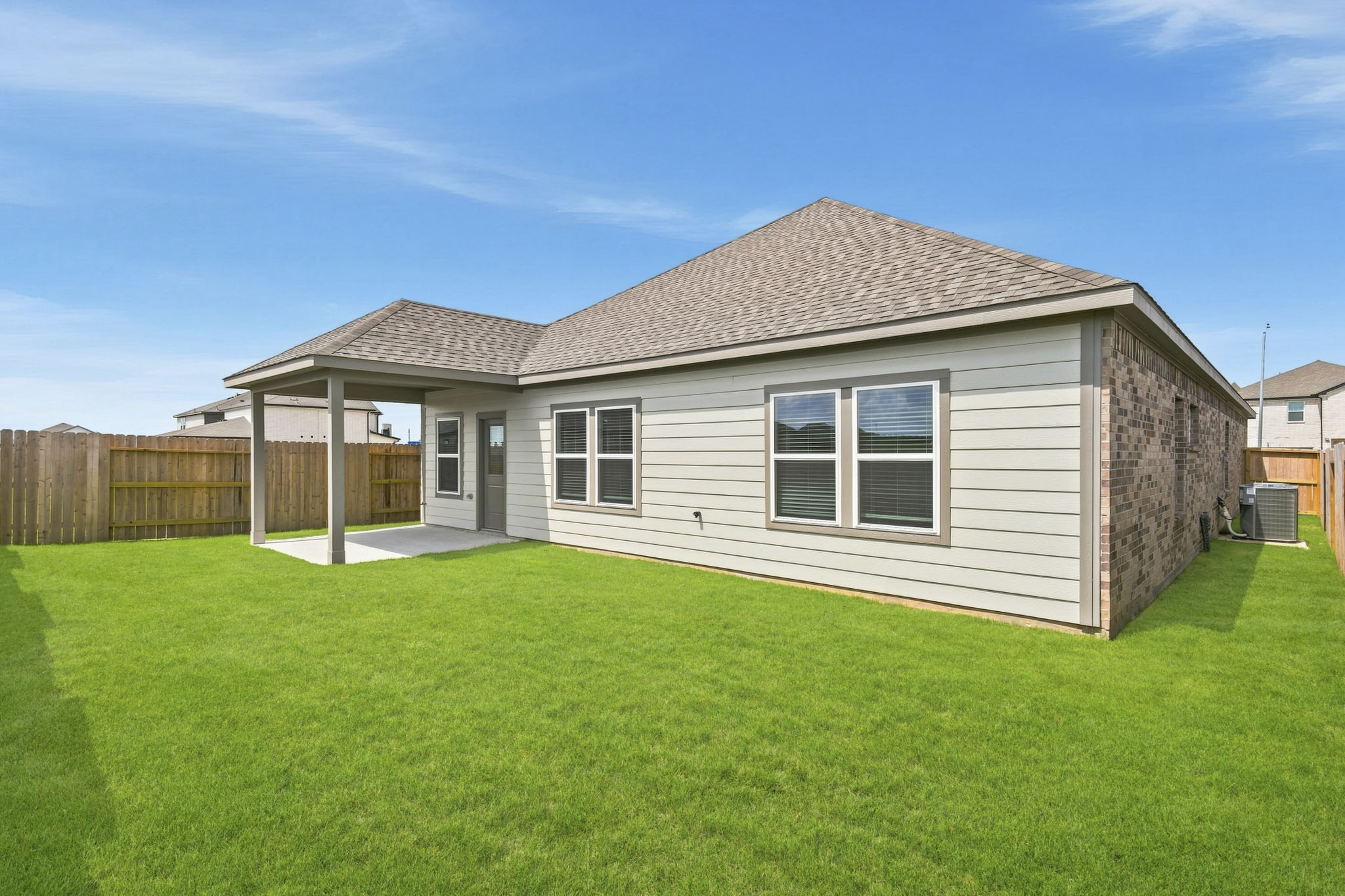 A house with a fence and grass.