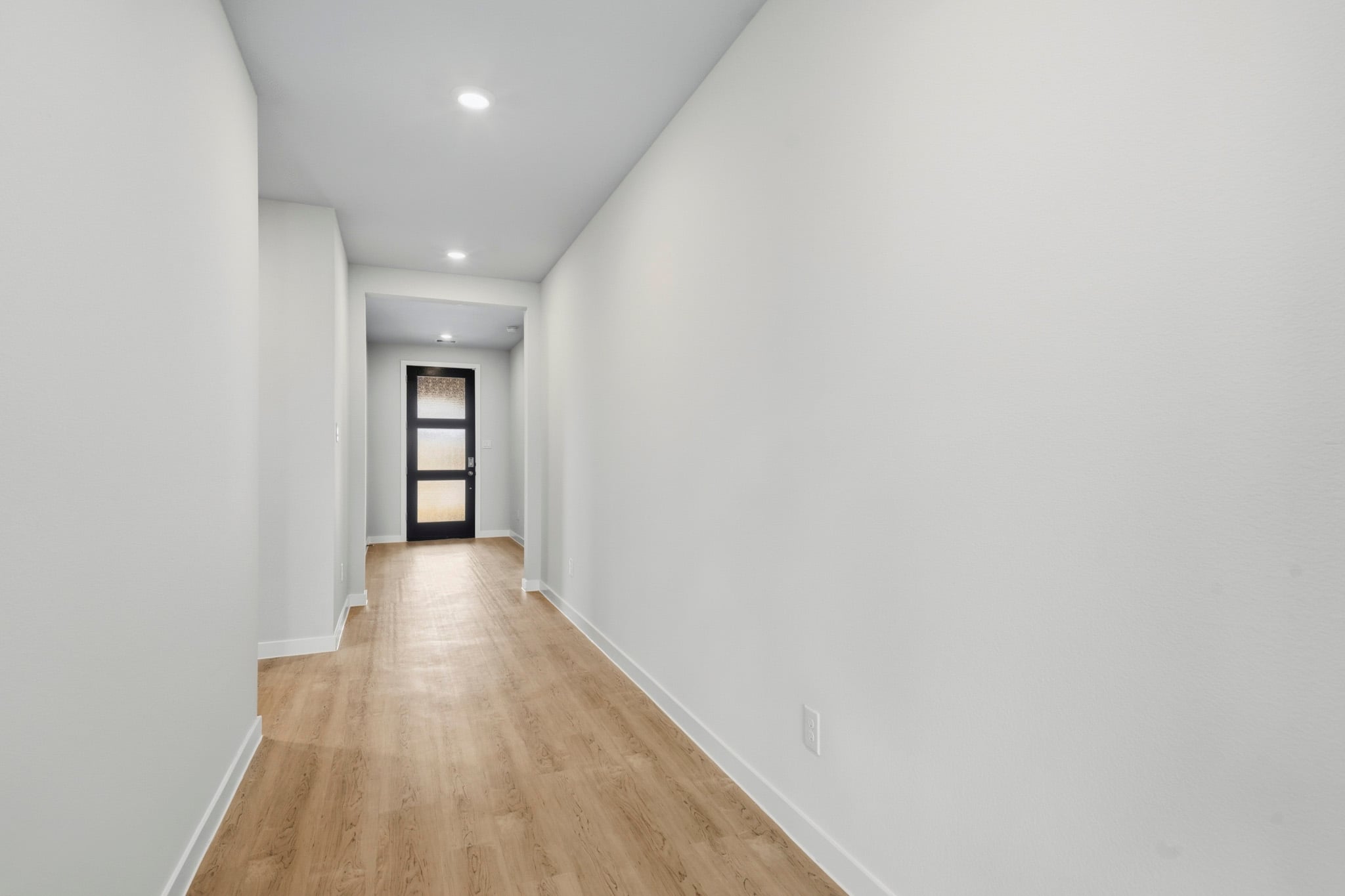 A hallway with white walls.