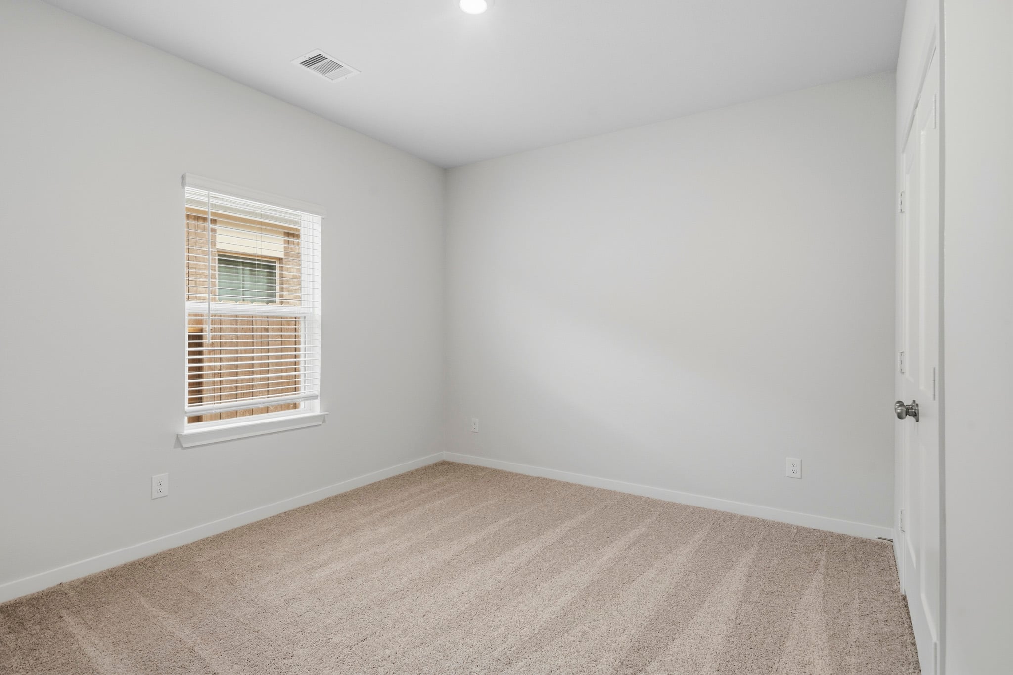 A room with a window and a door.