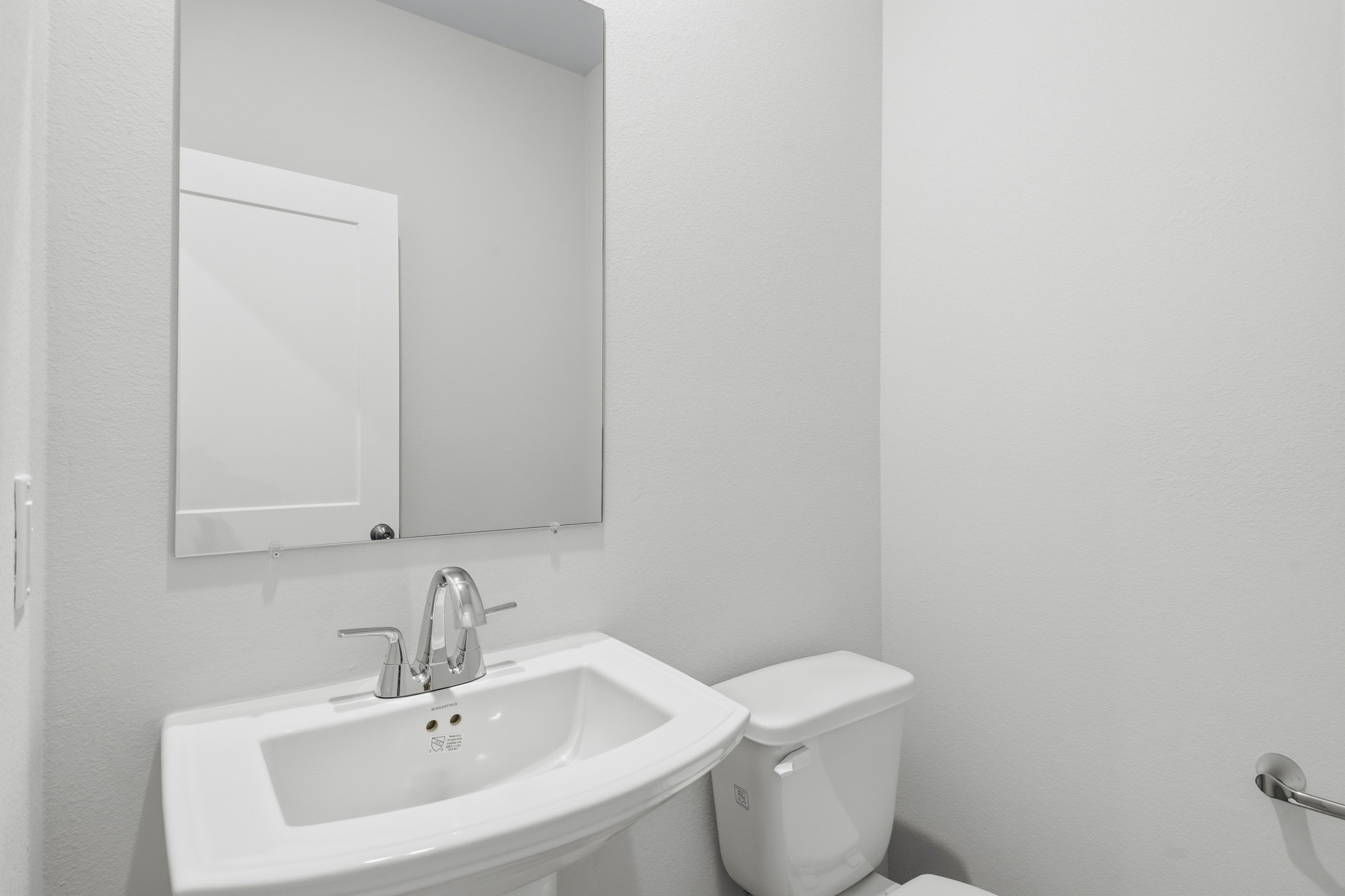 A bathroom with a sink and toilet.
