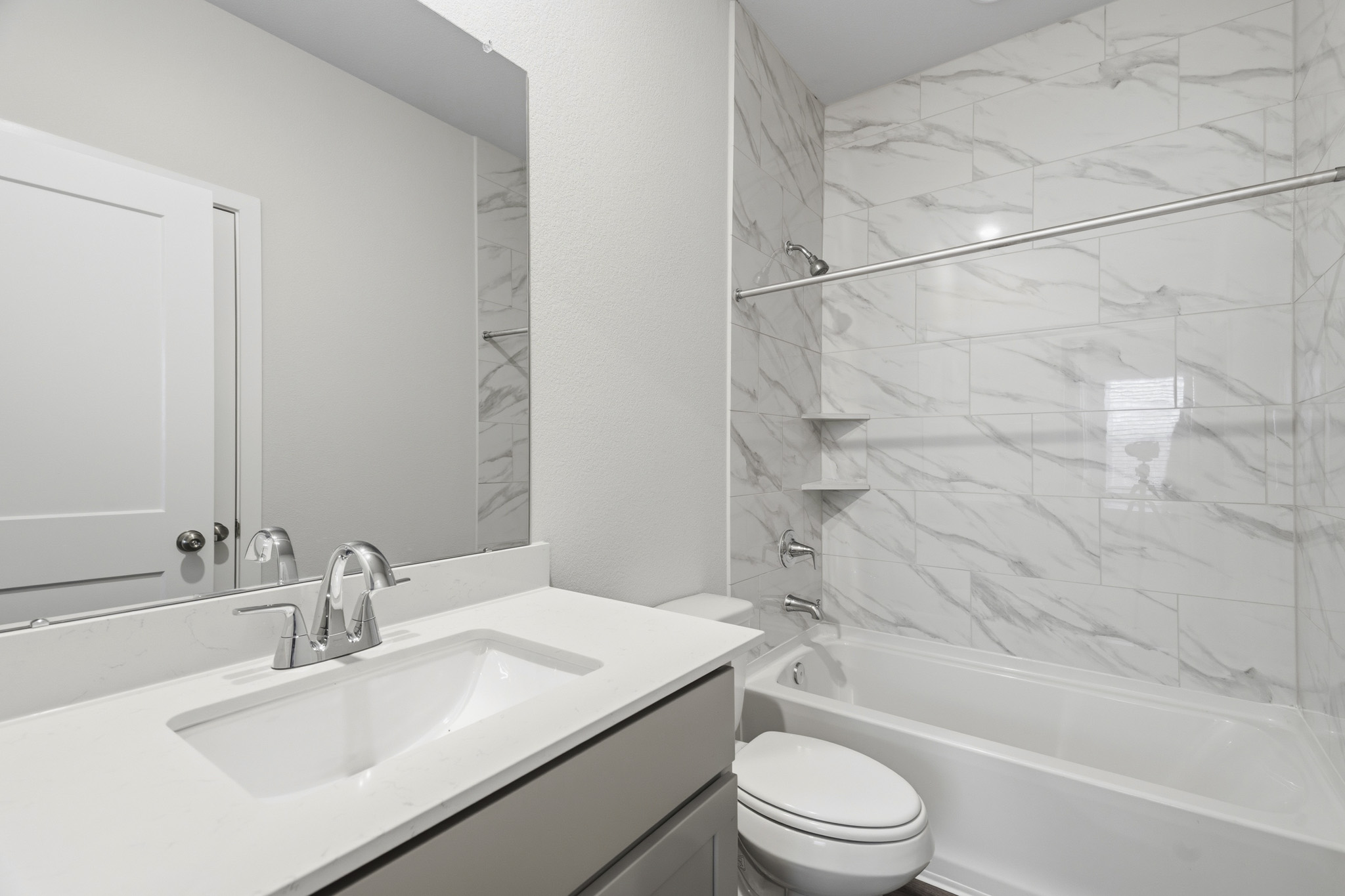 A bathroom with a shower and sink.