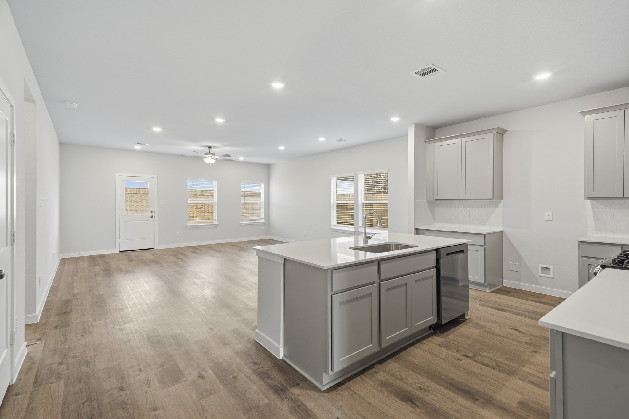 A kitchen with white cabinets.