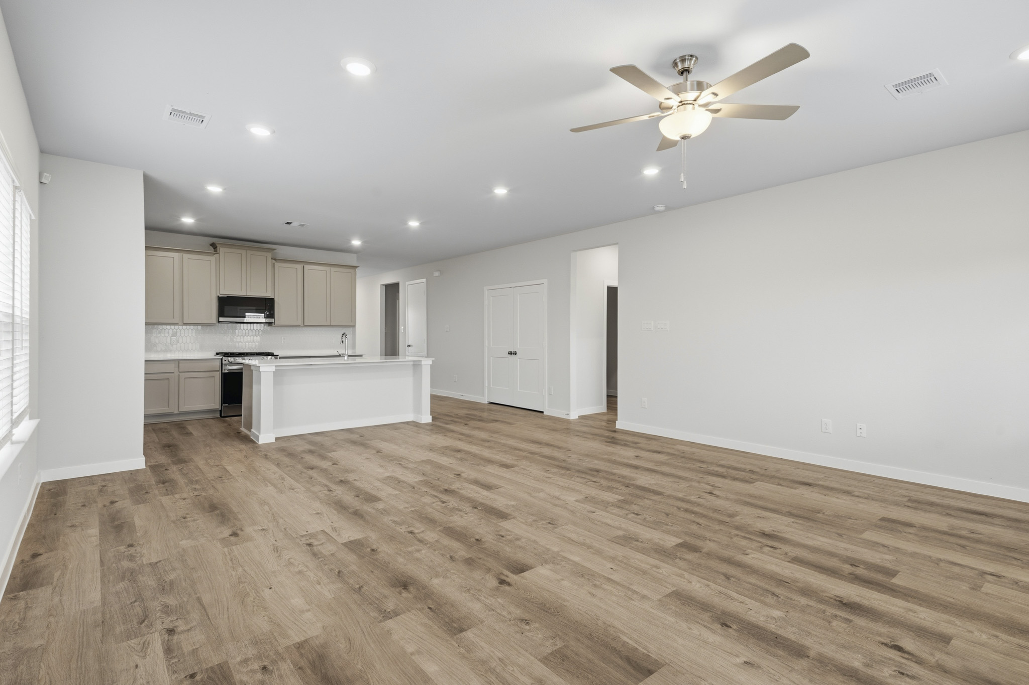 A large kitchen with a wood floor.