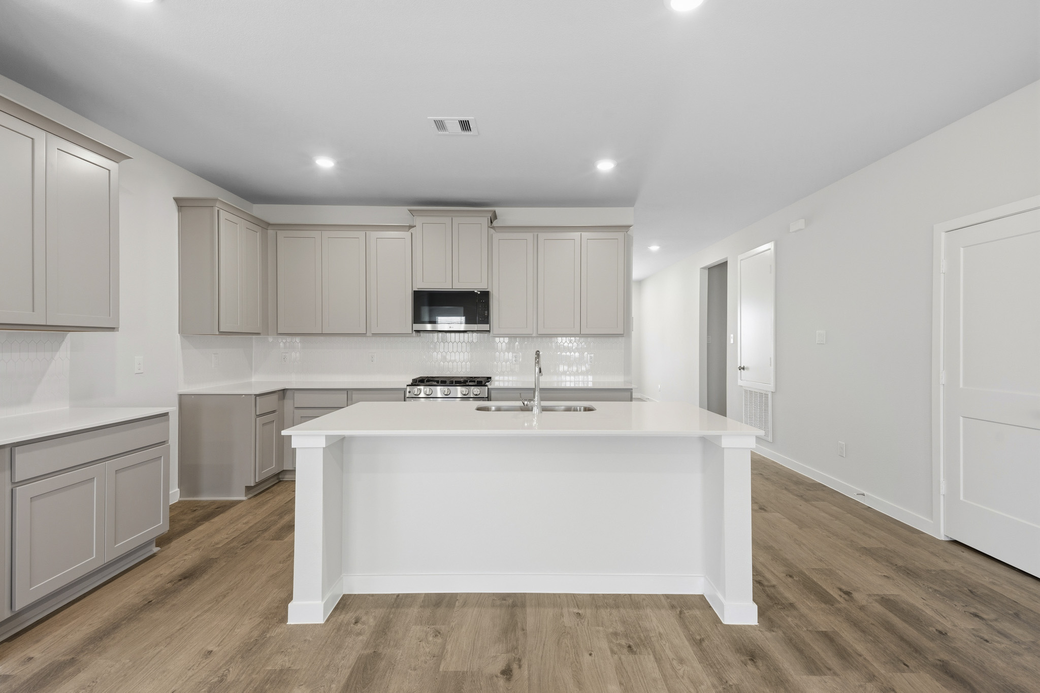 A kitchen with white cabinets.