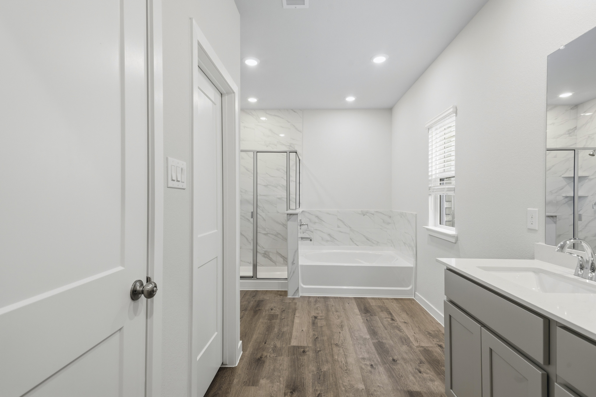 A bathroom with a tub and sink.