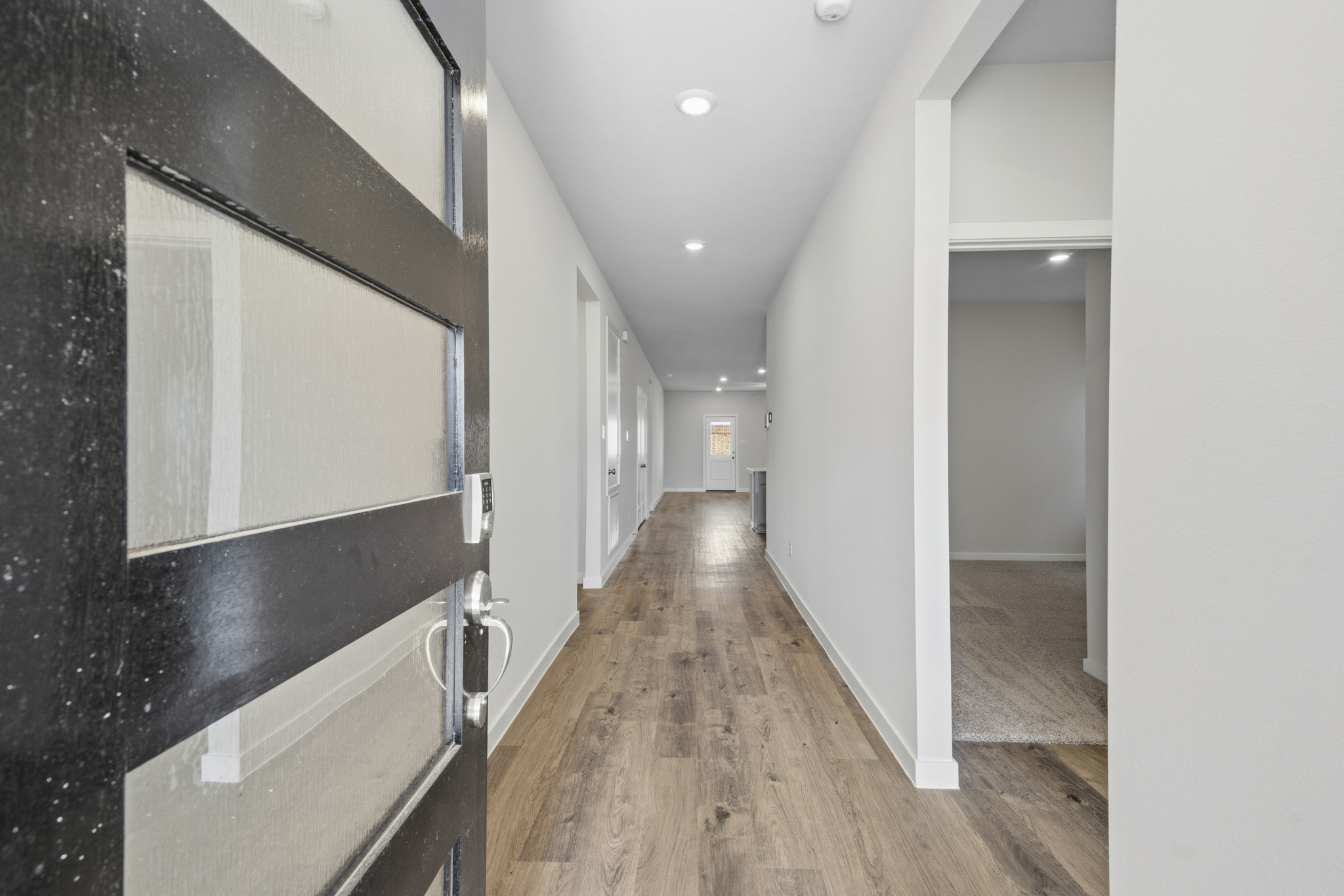 A hallway with a mirror.