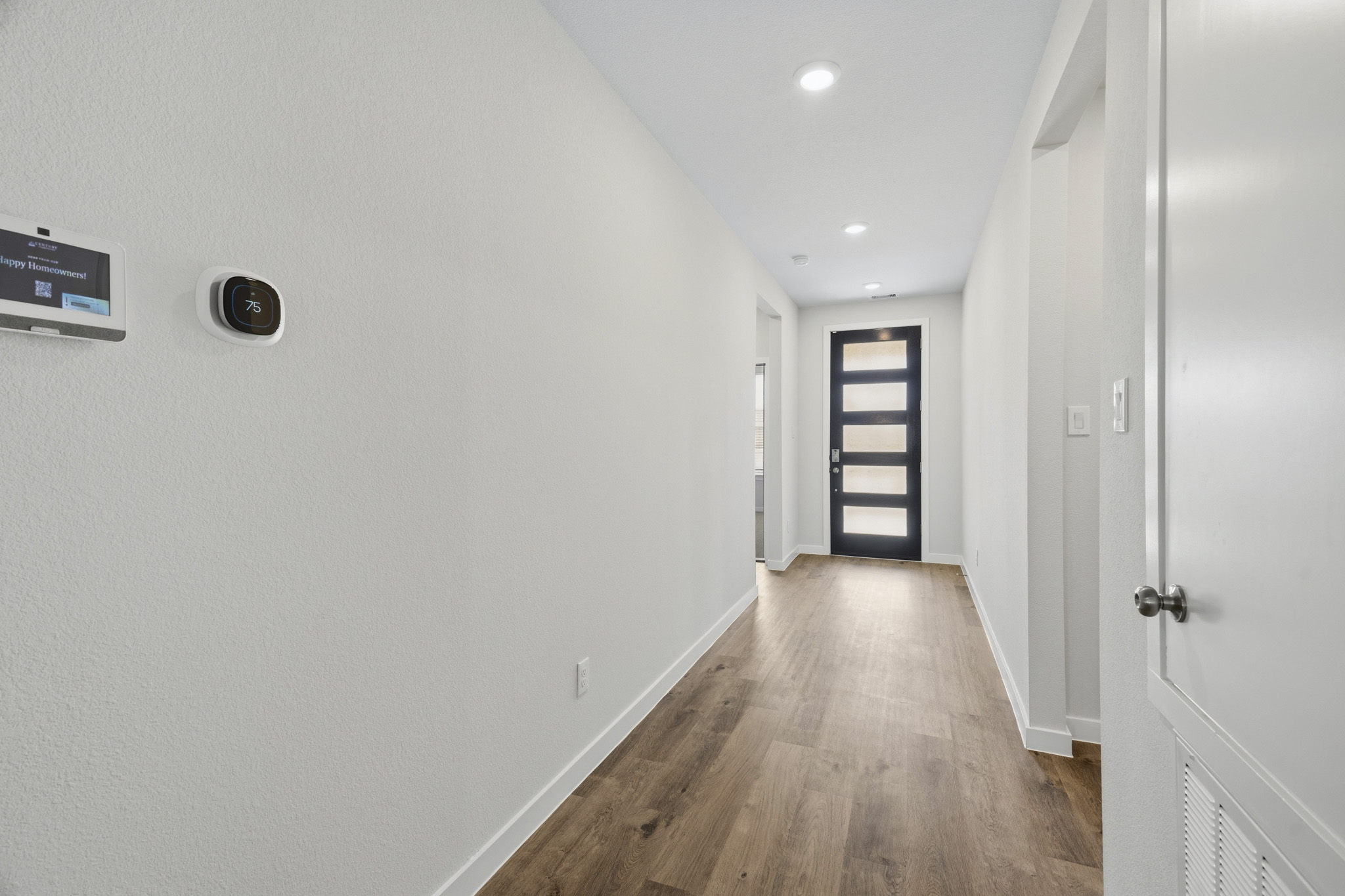 A hallway with white walls.