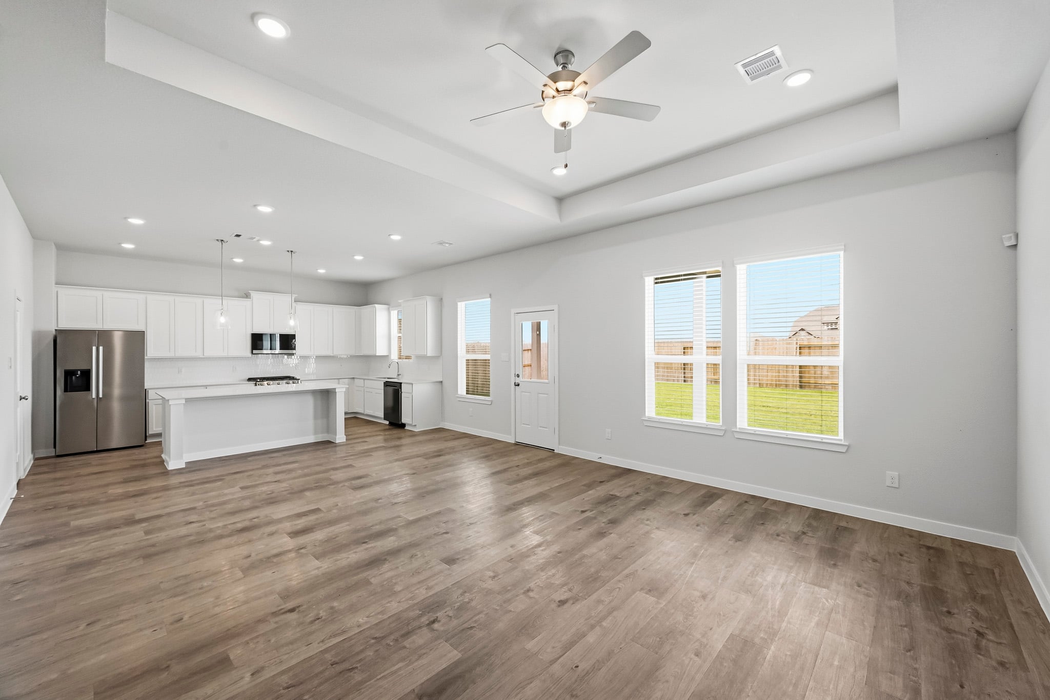 A kitchen with white cabinets.
