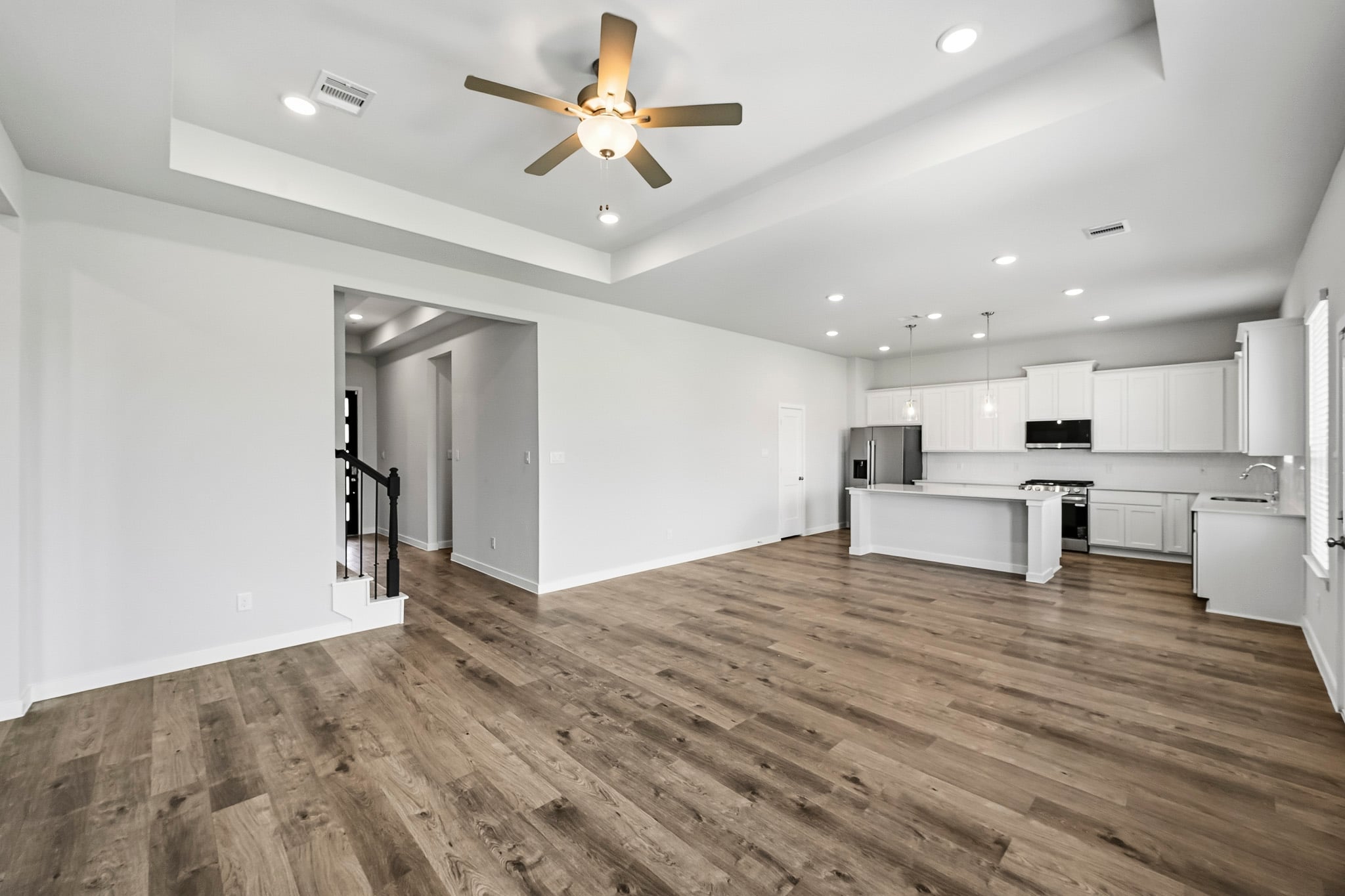 A large kitchen with white cabinets.