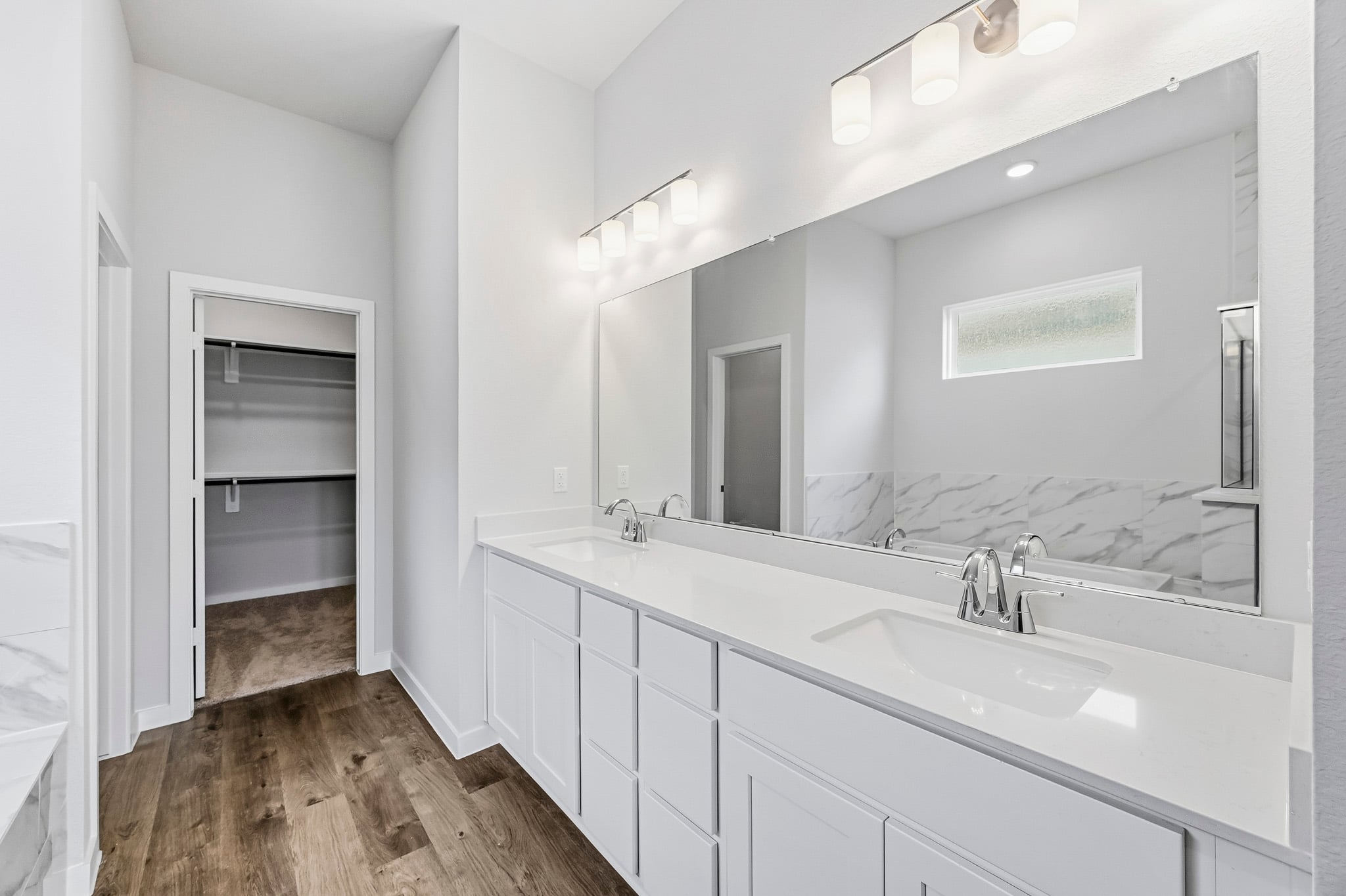 A bathroom with a large mirror.